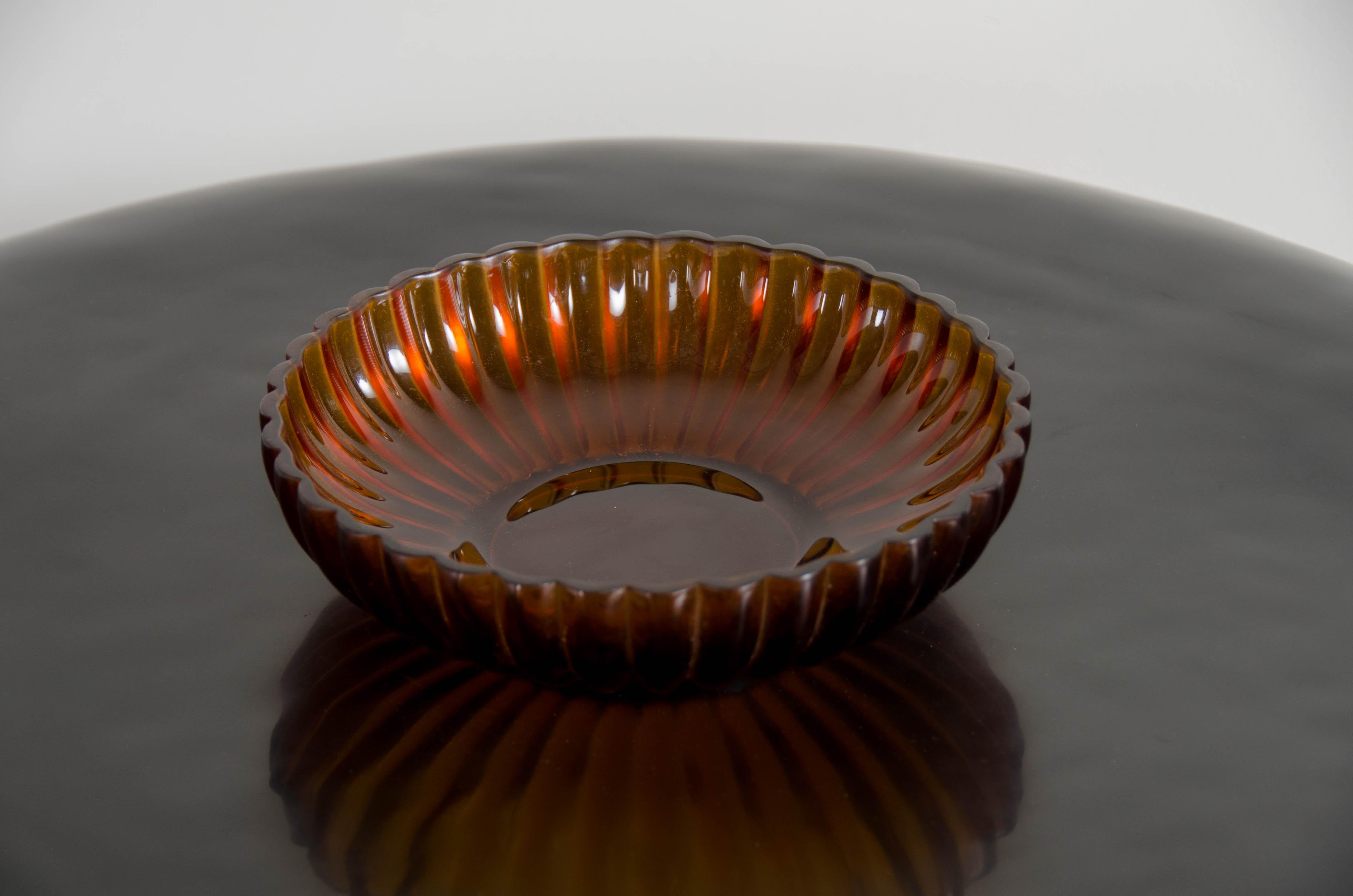 Chrysanthemum bowl 
Amber Peking glass
Hand blown glass
Hand carved
Limited Edition

Peking glass refers to the high-quality glass art produced by the imperial and commercial workshops in Beijing during the Ching Dynasty, China 1644-1911.