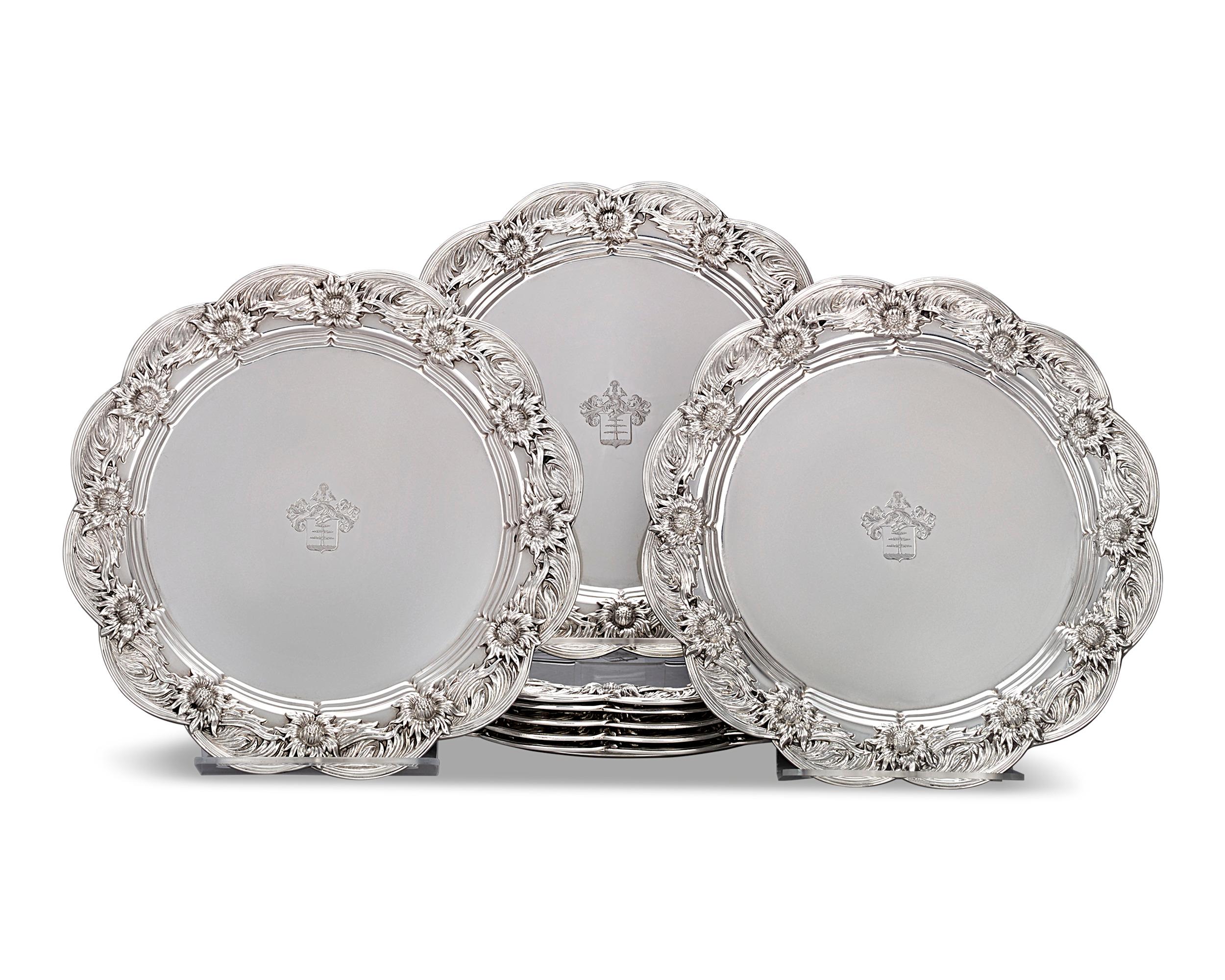 This beautifully crafted set of eight sterling silver dinner plates features the highly regarded Chrysanthemum pattern. Made by Tiffany & Co., each plate is masterfully executed, from their elaborate floral motifs to the delicately etched coat of