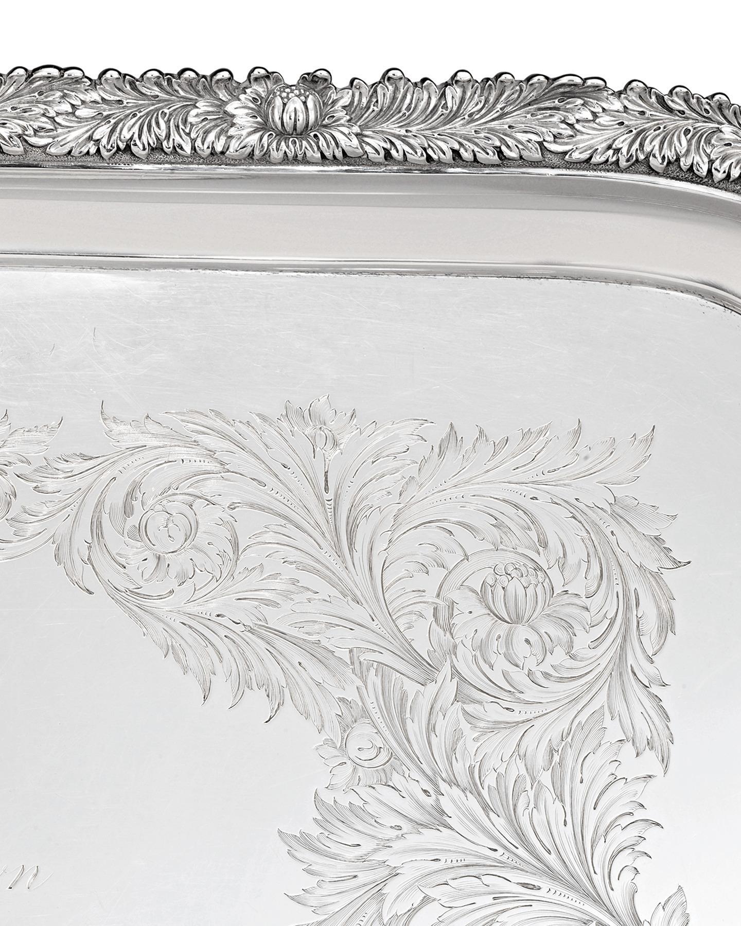This absolutely monumental sterling silver tea tray by the famed Tiffany & Co. was crafted in the firm's famed Chrysanthemum pattern. This opulent motif's signature flowers are masterfully chased along the tray's border. Furthermore, the body of the