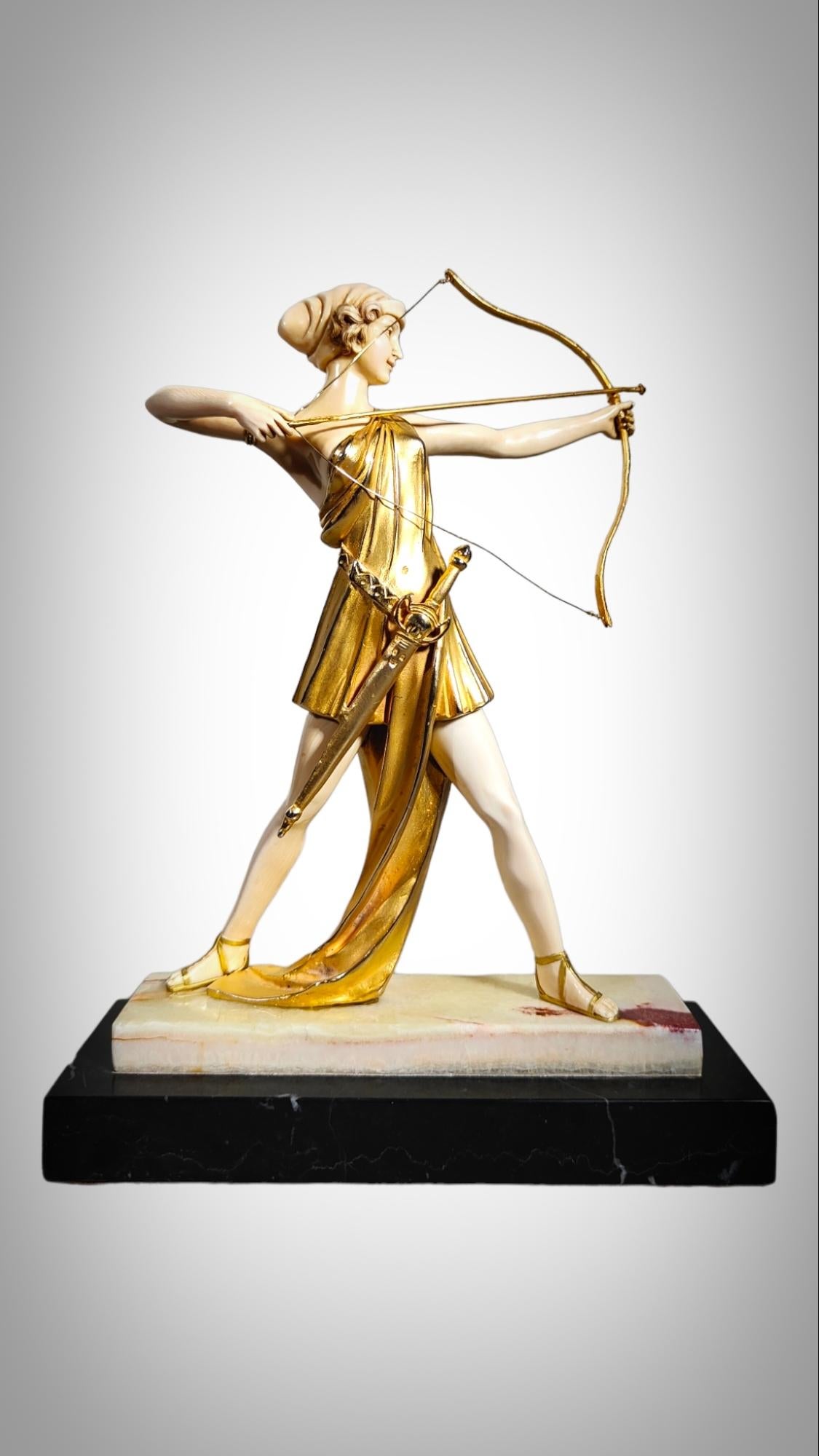 Chryselephantine sculpture, gilded bronze  resting on an onyx base, representing Diana
A magnificent early 20th century Art Deco chryselephantine figure of a beautiful young woman shooting her bow and arrows with a classic gilded bronze raised on an