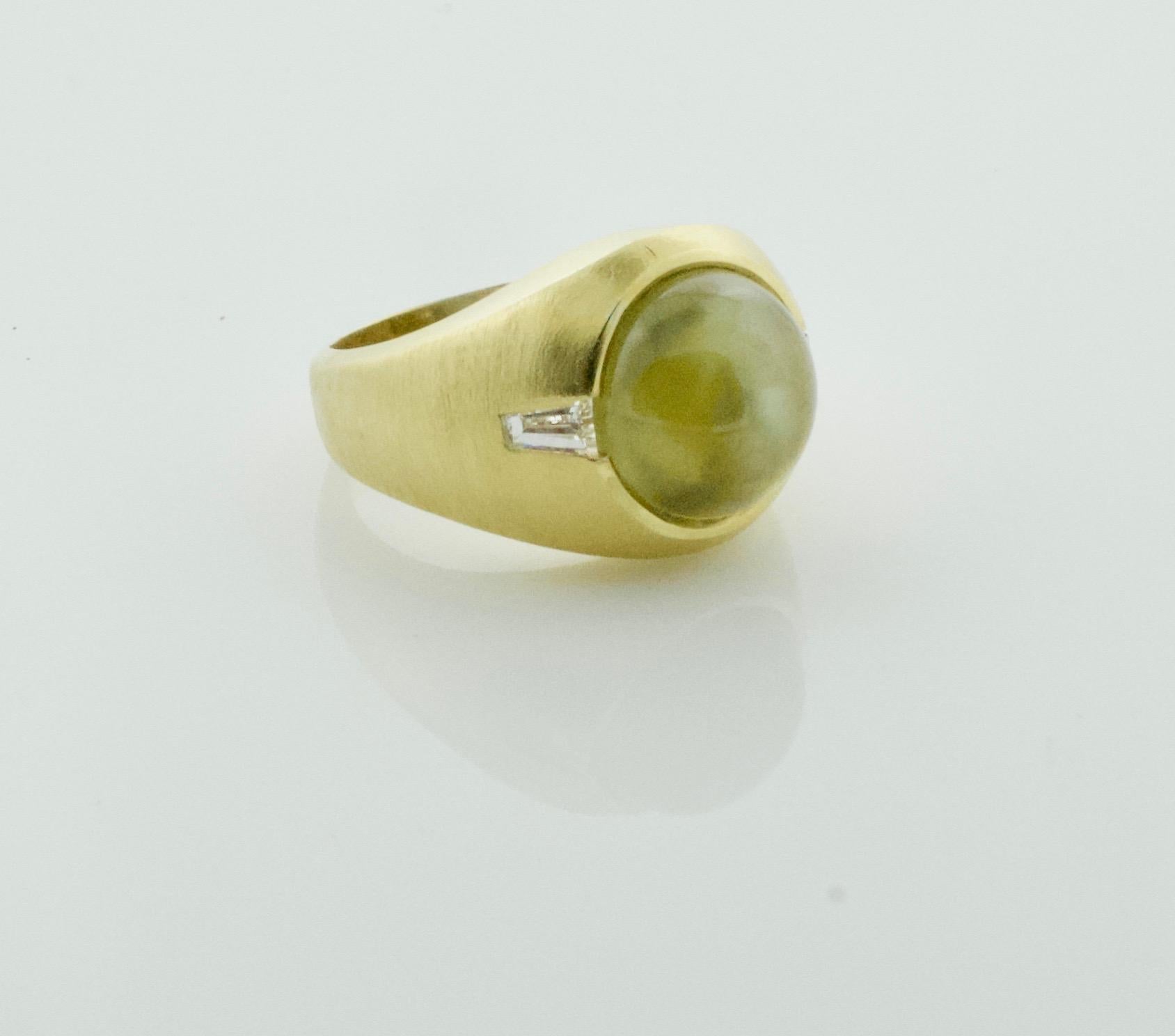 Chrysoberyl Cats Eye 11.10 Carats and Diamond Ring in 18k
Two Tapered Baguette Diamonds Weigh .37 [GH VVS]
Currently Size9 Can Be Sized By Us Or Your Qualified Jeweler
A Ultimate Pinky Ring 