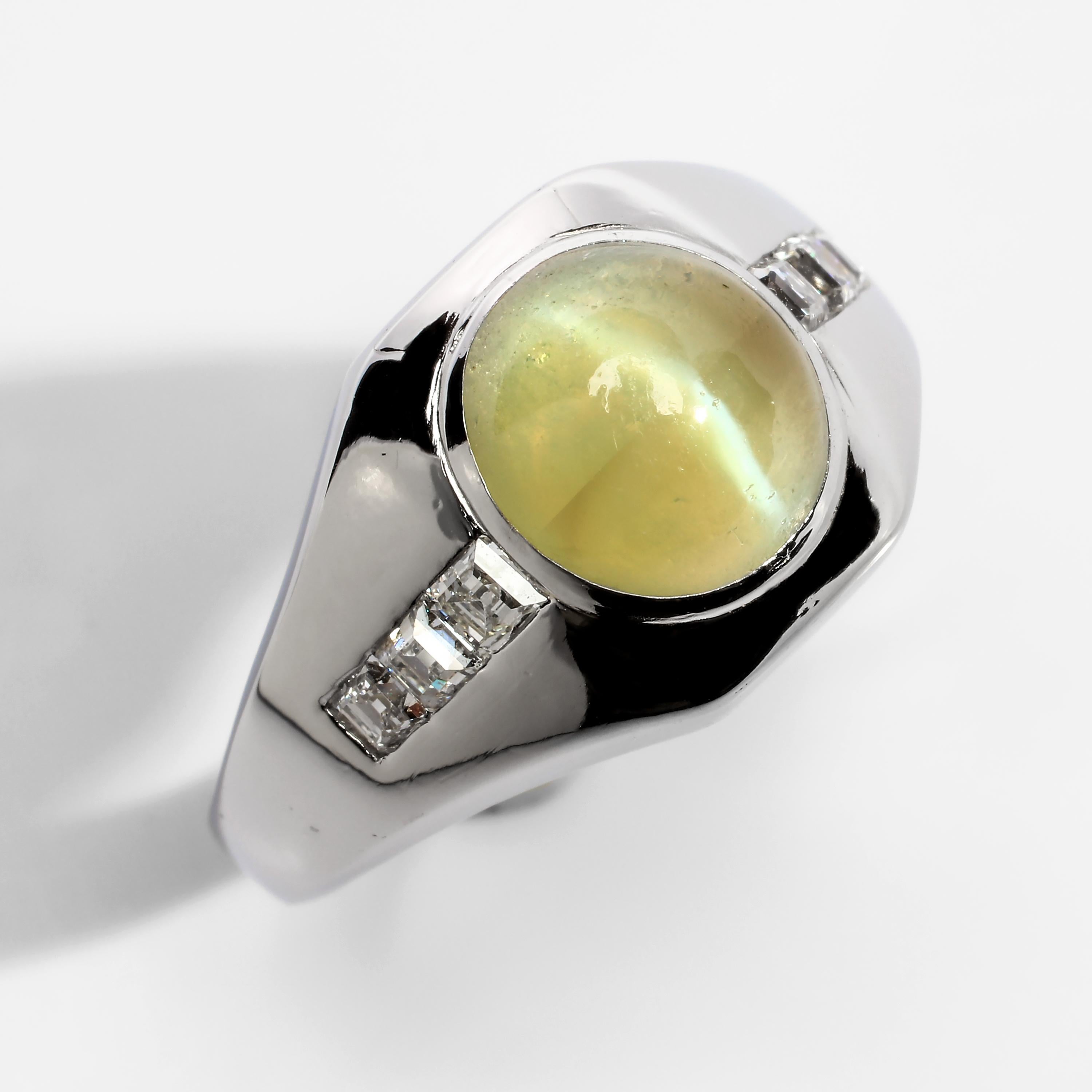 This chrysoberyl cat's eye ring is in an unusual pomelo olive color with extremely high translucency and a strong, well-defined white line. The clean, graceful curves of the setting are reminiscent of the Art Deco era but this more likely a