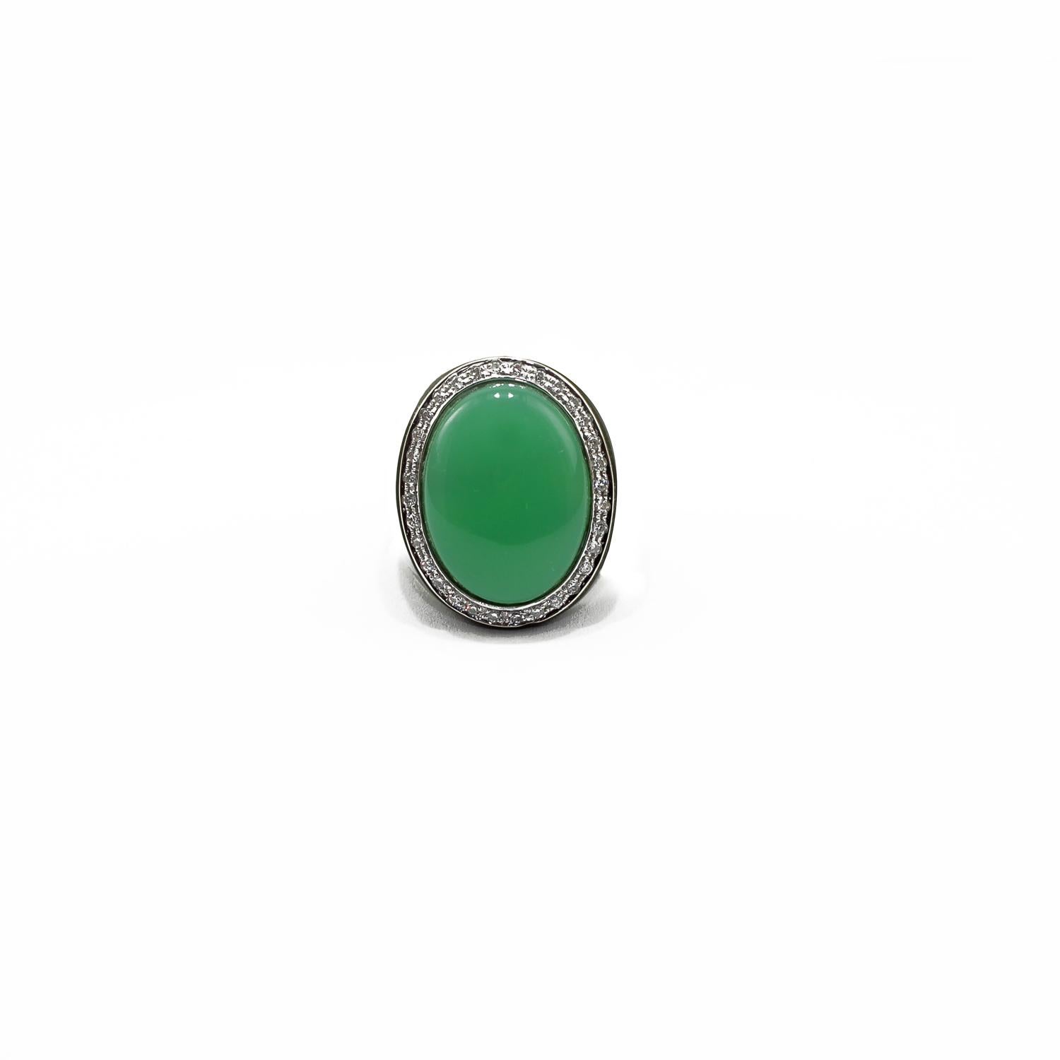 Elegant ring in green bakelite, 18kt white gold, white diamonds frame and chrysophrase cabochon. 
White Gold g. 3
White diamonds ct. 0.32
Chrysophrase cabochon size 25x20 mm
Size 12 (ita) 6.25 (usa) 52 (fra) 

