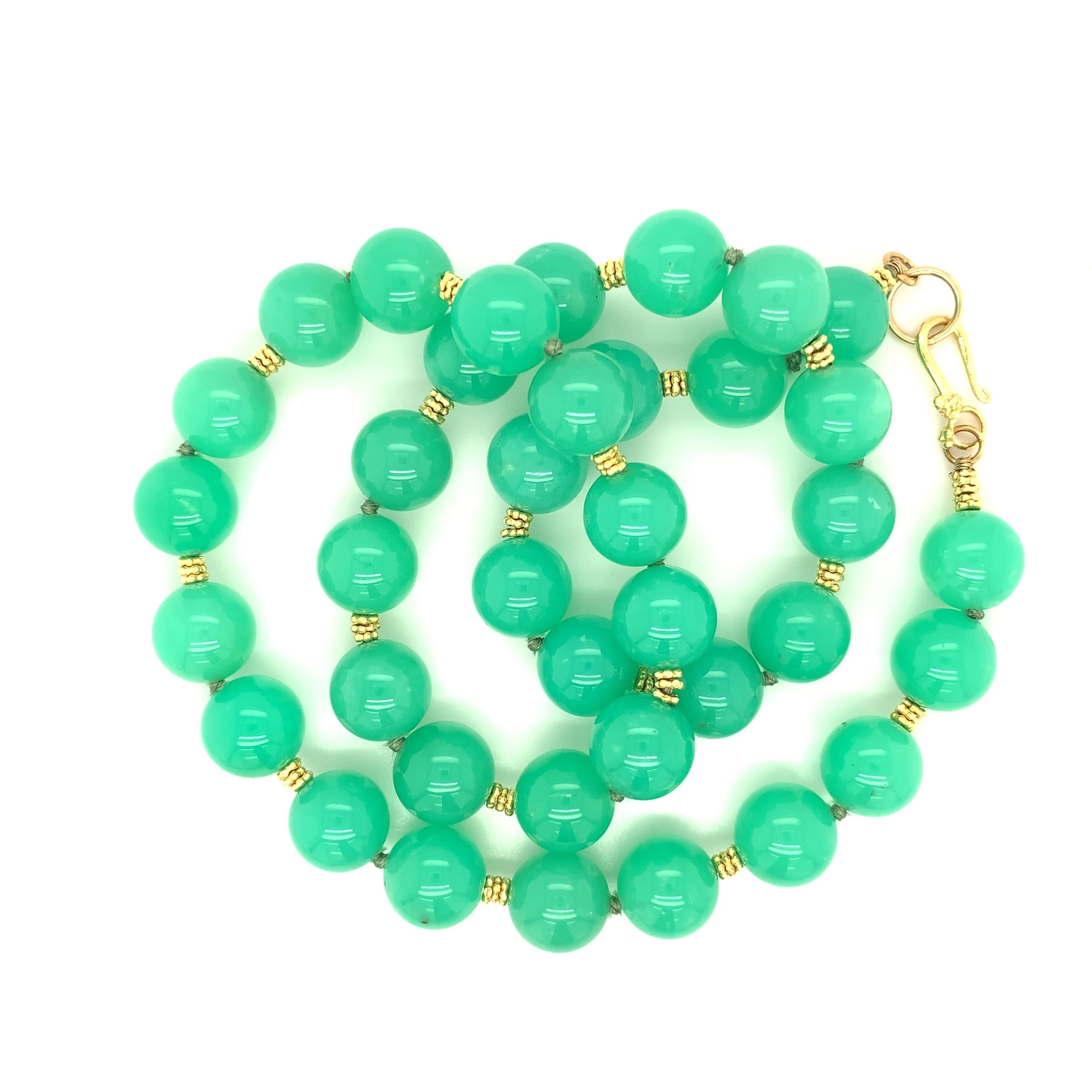 This glorious necklace features a strand of 11.00 millimeter fine chrysoprase beads of stunning color and quality. Chrysoprase is a variety of the gem material, chalcedony. These apple green beads are semi-translucent with beautiful luster, and have