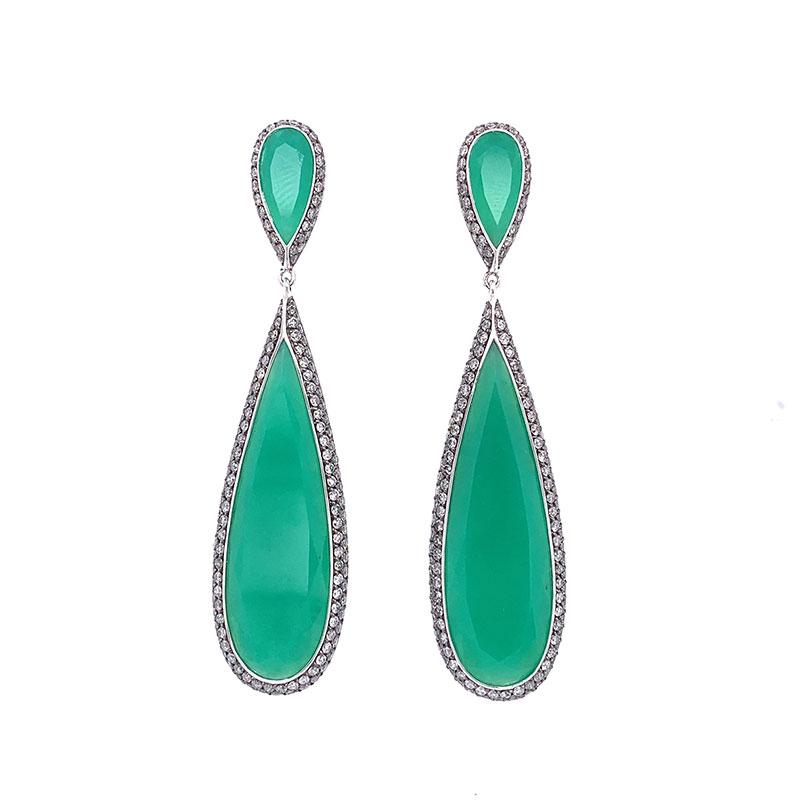 A magnificent pair of earrings with stunning sets of chrysoprase, the green variety of chalcedony. The 4 pieces of chrysoprase, weighing a total of 31.70 carats, are perfectly cut to match. They are accented by 5.12 carats of round brilliant cut
