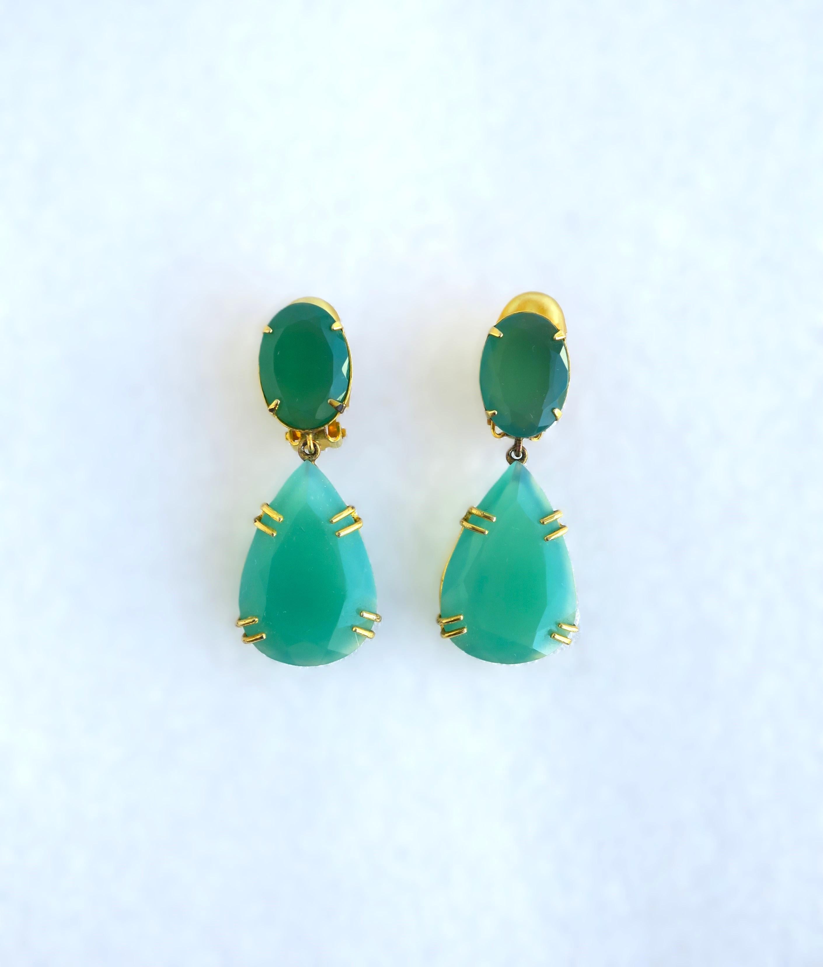A stunning and relatively large pair of Chrysoprase drop earrings, circa early-21st century. Earrings feature faceted oval and pear green Chrysoprase stones, embraced by a gold-tone metal finish setting. A beautiful green hue similar to emerald