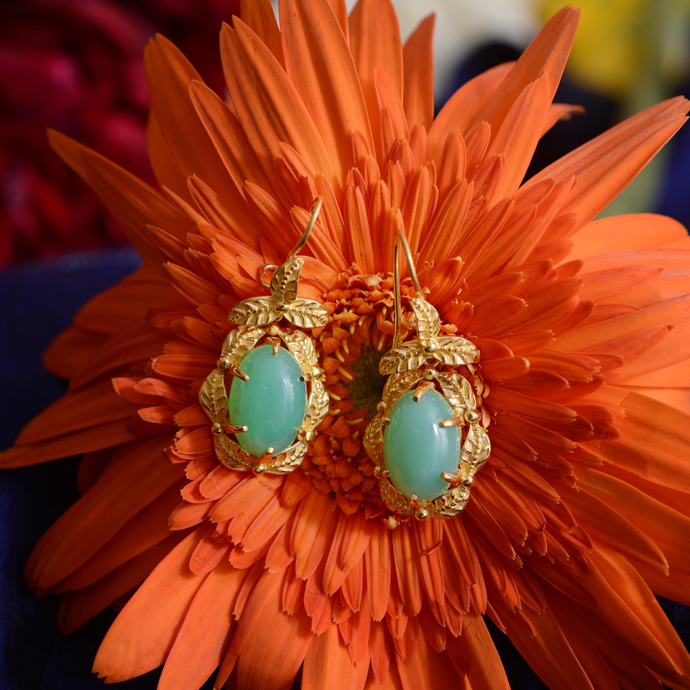

These gorgeous earrings have been handmade in our workshops. They feature chrysoprase drops which are set in exquisite hand engraving work. The earrings are made in sterling silver coated in 24k gold vermeil. They have a matching pendant, bracelet