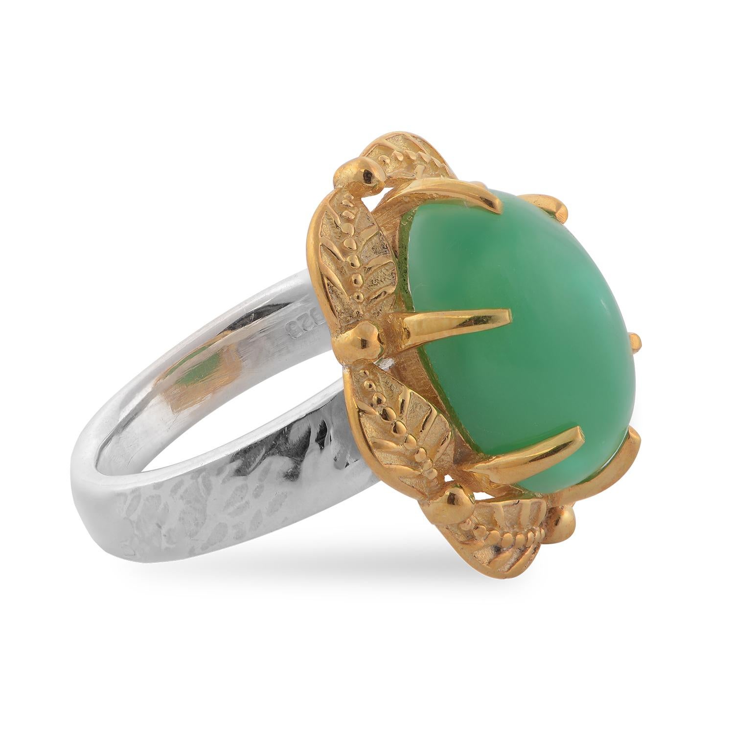 

This gorgeous ring has been handmade in our workshops. It is embedded with a chrysoprase which is set in exquisite hand engraving work. The ring is made in sterling silver coated with 24ct gold vermeil.

It has a matching pendant, earrings and