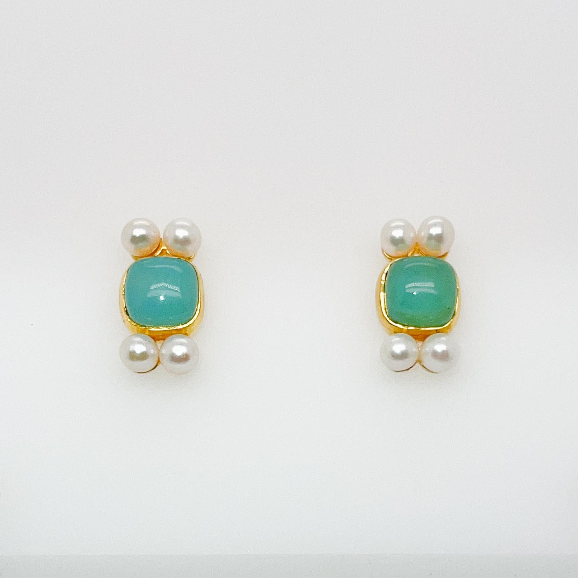 A very fine pair of 14k gold post earrings.

With a square smooth chrysoprase cabochons center set and framed by four small, round white pearls at top and bottom.

Simply a lovely pair of gold post earrings!

Date:
20th Century

Overall