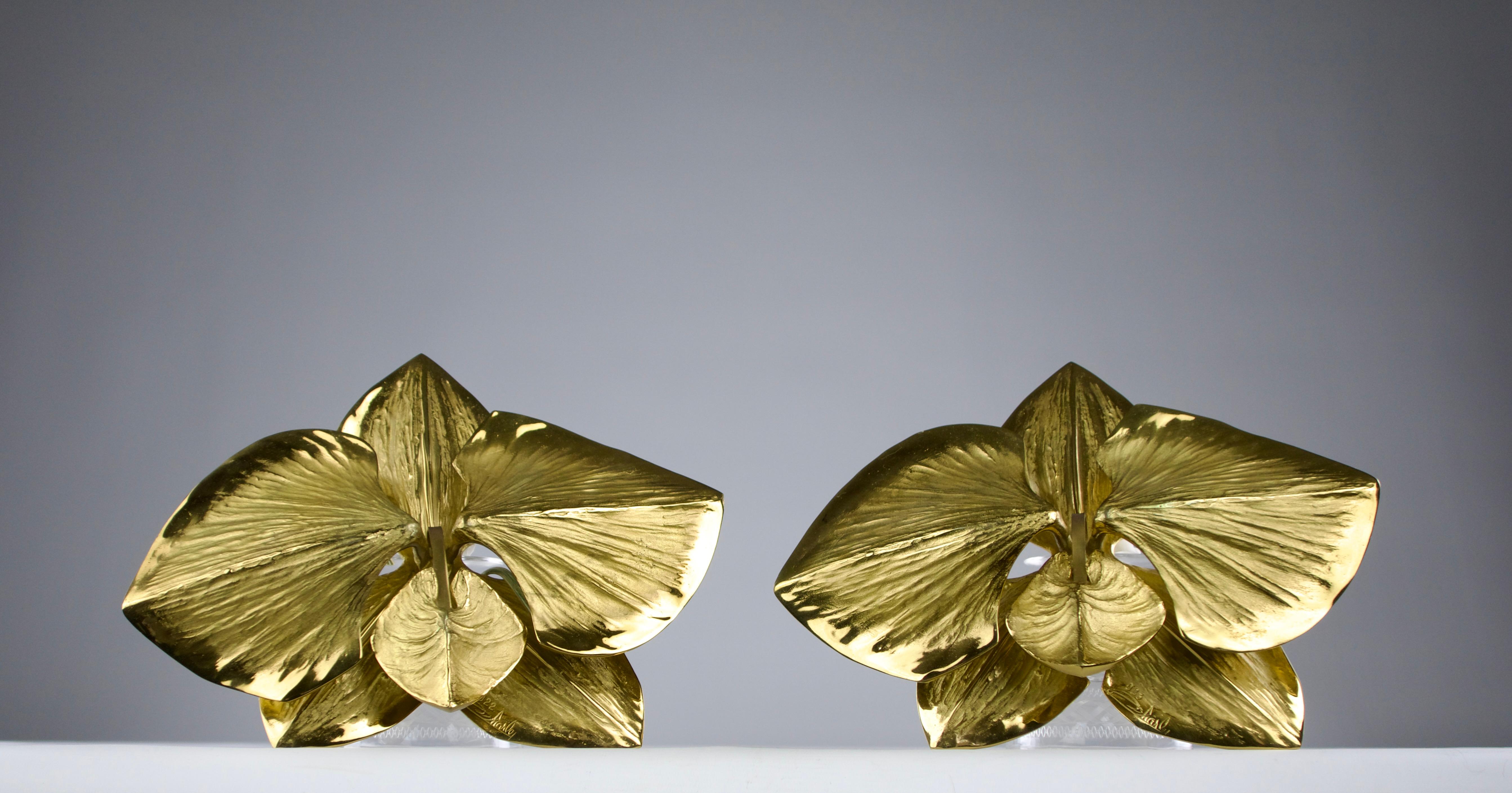Superb Maison Charles Orchid wall light sconces in golden polished brass, designed by Chrystiane Charles in the 1980s. Numbered 022 and 023. Signed Charles on the sconces and Maison Charles, Made in France on the back mounts.

In very good