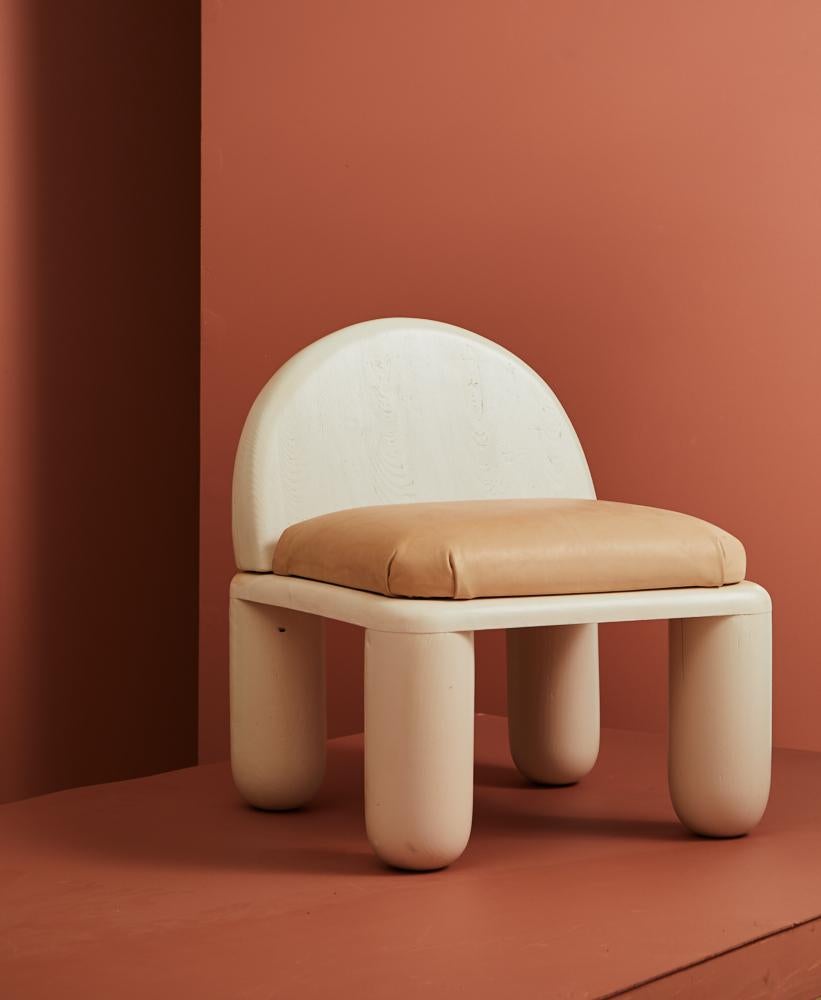 The Chubby chair is a low lounge chair that creates a warm and comforting vibe in any room it inhabits. Made from hand carved and turned Tulip poplar wood with an upholstered vegetable tanned leather seat, the piece evokes a sense of lightness both