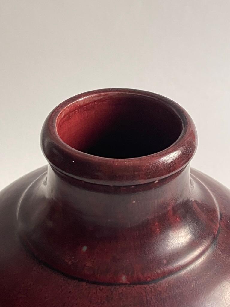 Chubby beautiful oxblood red stoneware vase by pioneering ceramicist Carl Halier (1873-1948) for Royal Copenhagen in 1935, Denmark. 
  