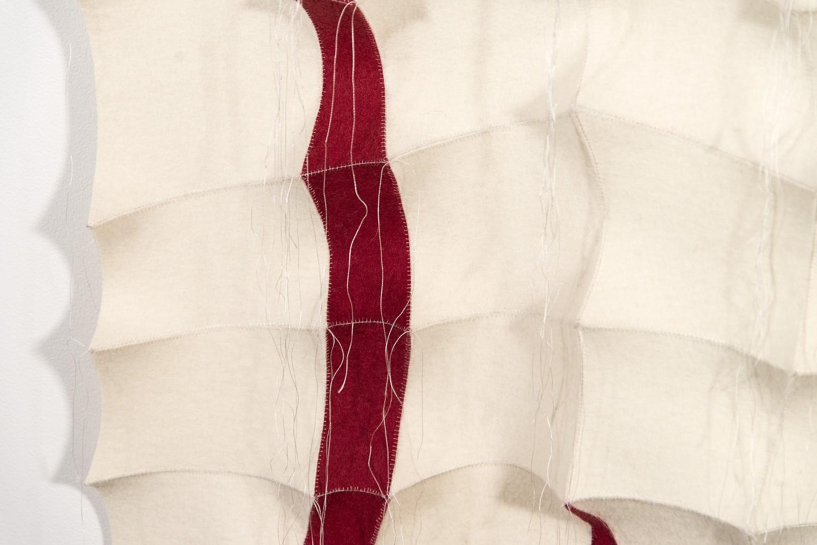 Striking organic shapes in bright red provide dramatic contrast in this cream felt tapestry by fabric artist Chung-Im Kim. Kim meticulously hand stitches together small pieces of industrial felt fabric, pulled taut to create tension in the design