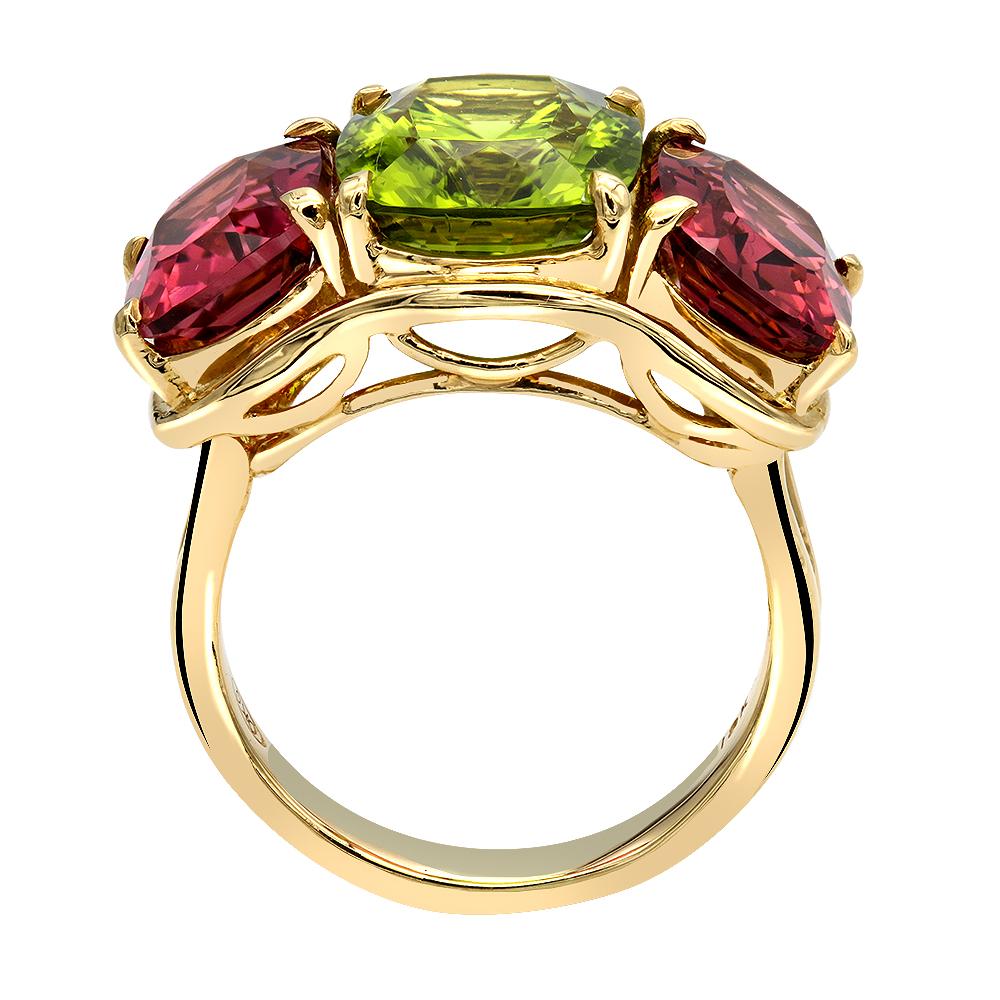 Ladies beautiful three stone ring.
Center contains 5.95 carat cushion cut peridot.
Two sides cushion cut pink tourmalines total weight 6.05 carat.
Handcrafted in 18k yellow gold.
10.7 grams.
Size 7 1/2.
33mm.
Expert Ring Sizing available on the