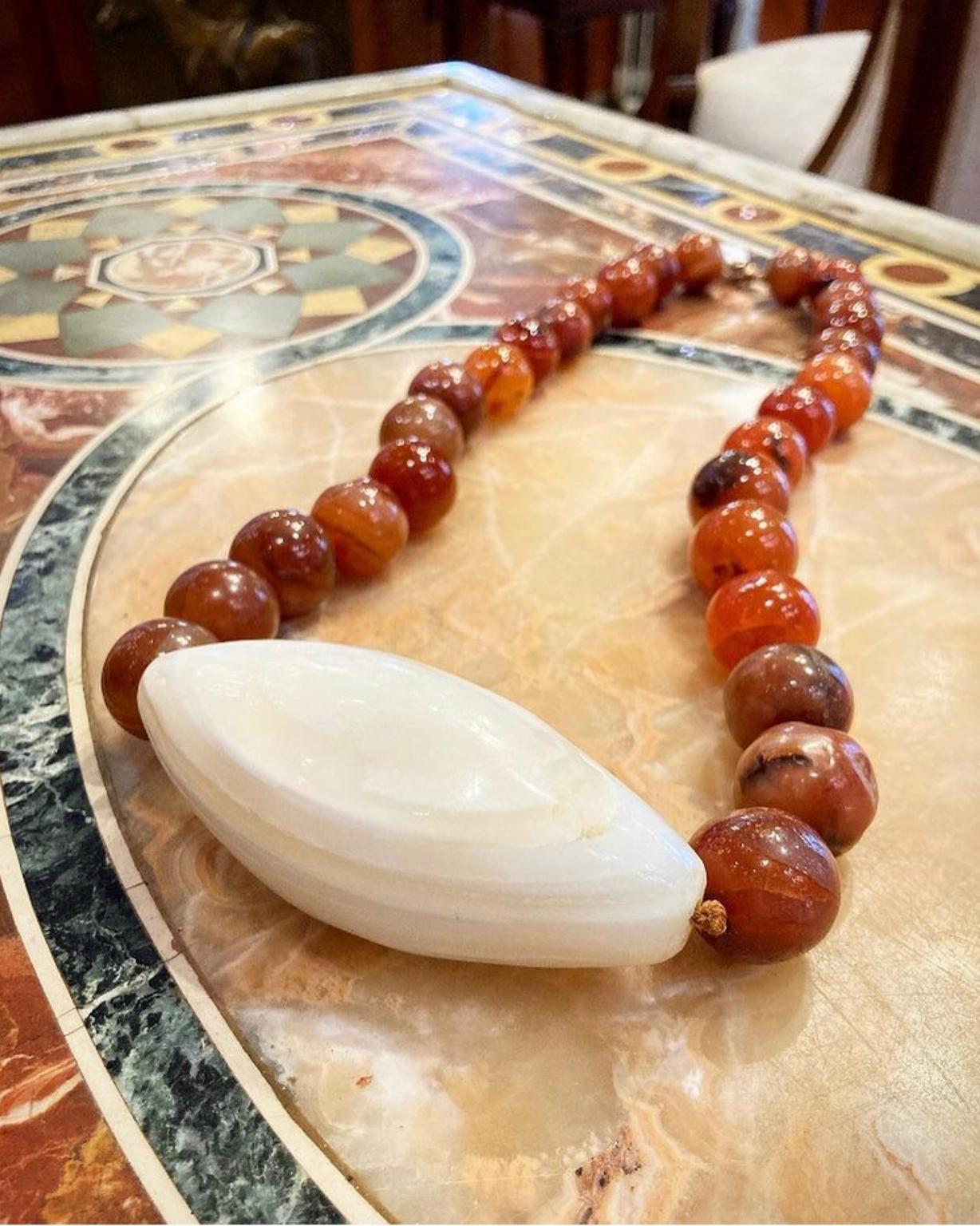 A stunning statement necklace comprised of jasper beads, centering a large agate pendant.