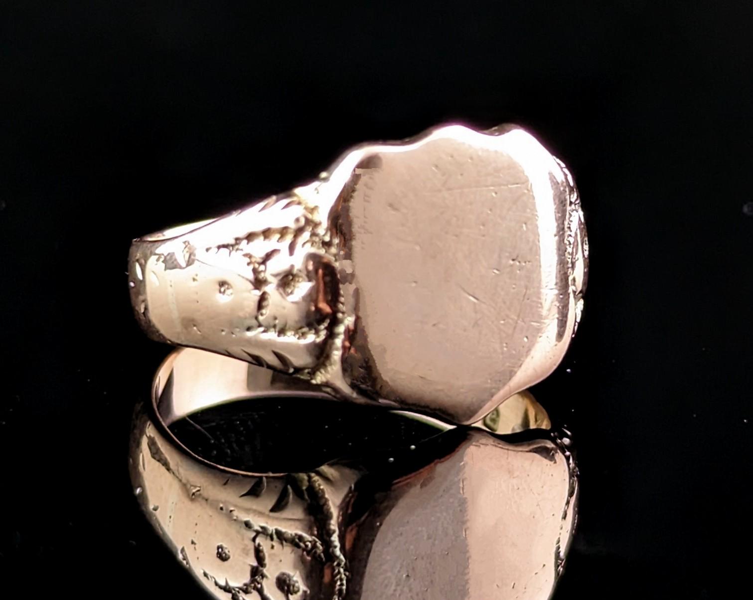 This handsome antique 9kt Rose gold signet ring has a warm cherished charm about it and a rich golden glow only found on older pieces.

It is a rose gold with pinky tones in 9kt.

It has a shield shaped face with no engraving or monograms so could