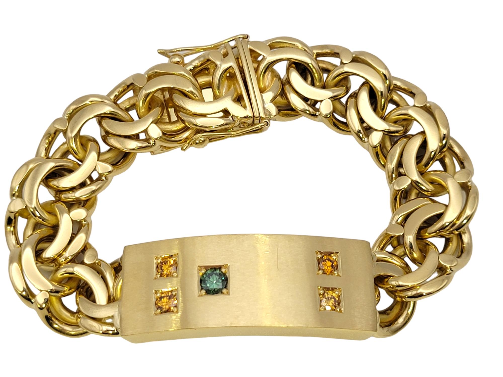 This eye-catching men's 18 karat yellow gold and colored diamond ID link bracelet makes a bold and luxurious statement. The contemporary design of this impressive piece looks handsome on the wrist, really drawing the viewers attention to the rich