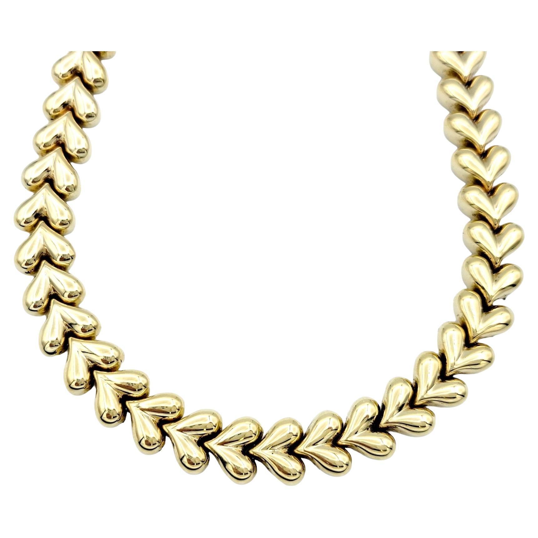 This charming and versatile 14 karat yellow gold link necklace is designed to capture hearts with its whimsical elegance. The necklace features unique heart-shaped links, each meticulously crafted with a high polish that radiates a brilliant shine.