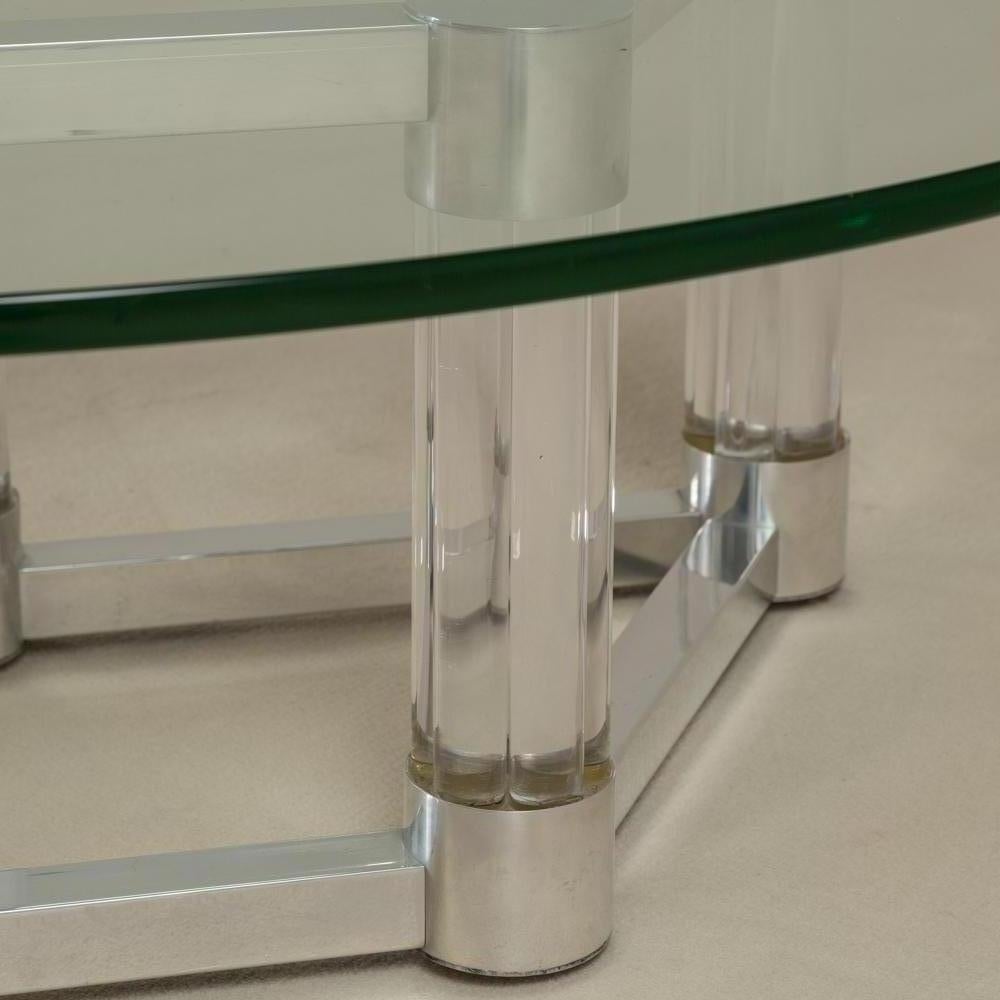 Brushed aluminium and lucite coffee table in a diamond shape with chunky Lucite columns capped at either end with aluminium and a glass top, 1970s.
Base dimensions H 40cm, W 85cm, D 51.5cm, 