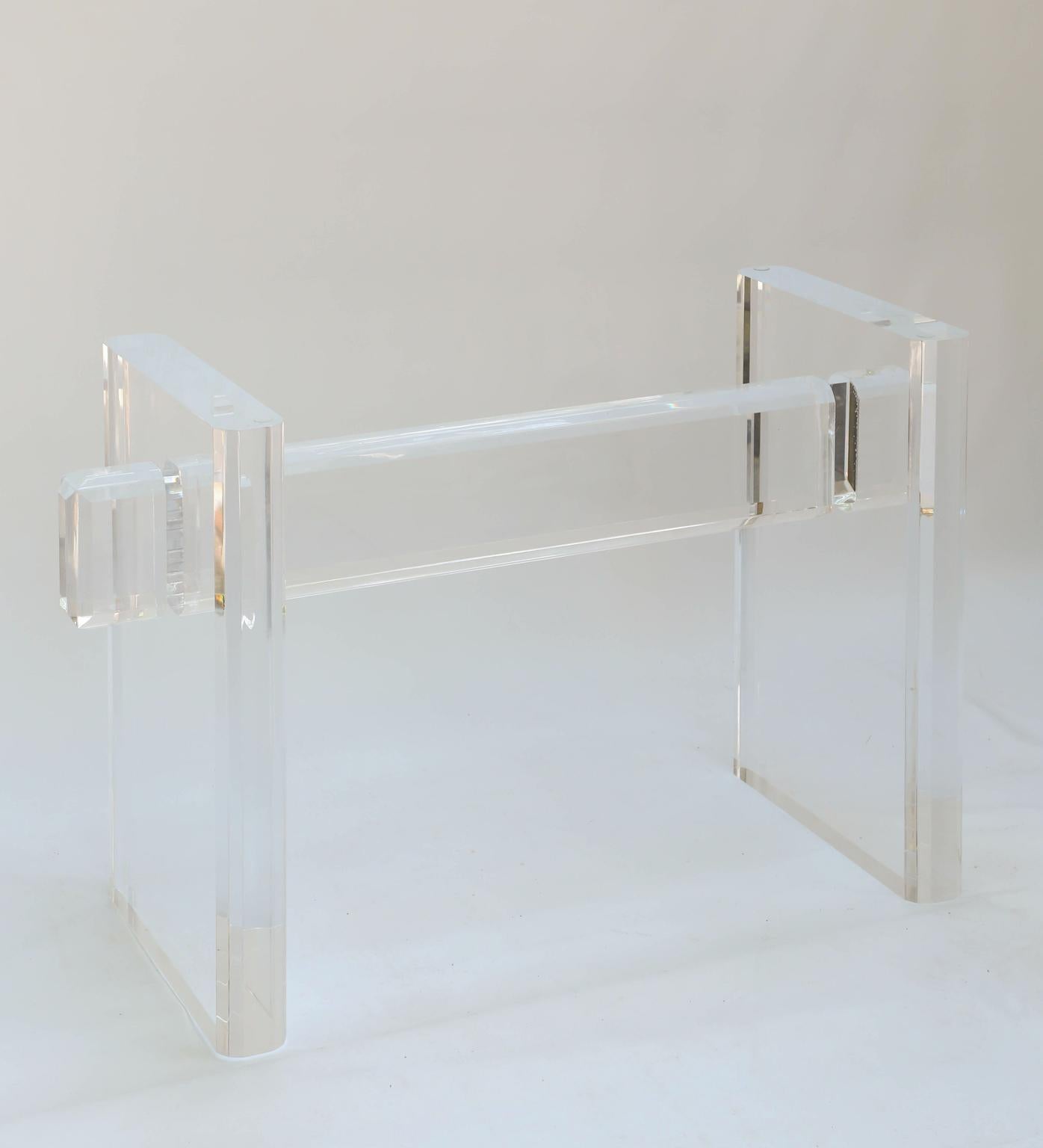 Karl Springer style Lucite table base. Its sculptural form consisting of two legs joined by cross stretcher of three-inch thick, solid acrylic, with rounded sides. The piece can also be used as the base for a console table.

Stock ID: D2857.