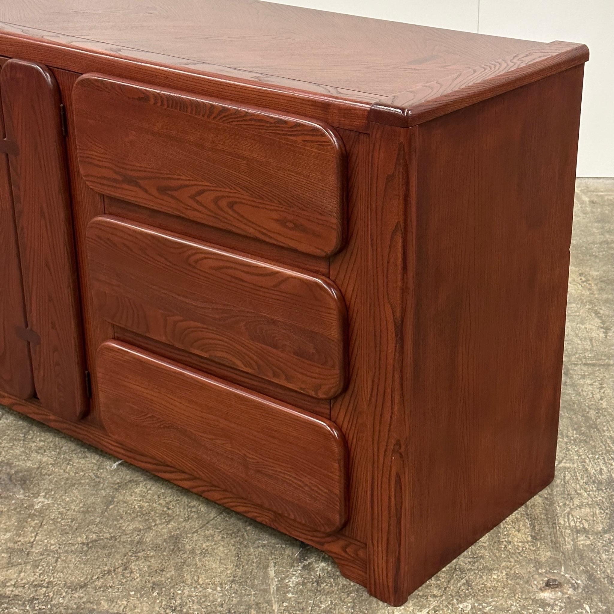 c. 1970s. Made by Stanley. Completely refinished in rosewood color although made of oak. Drawers inside middle cabinet. 