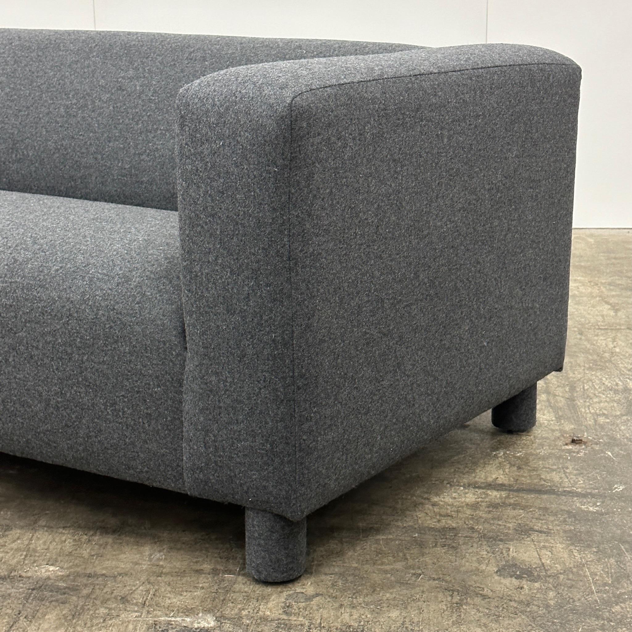 c. 1990s. Reupholstered in Camira Synergy charcoal wool fabric. Chunky legs covered as well.