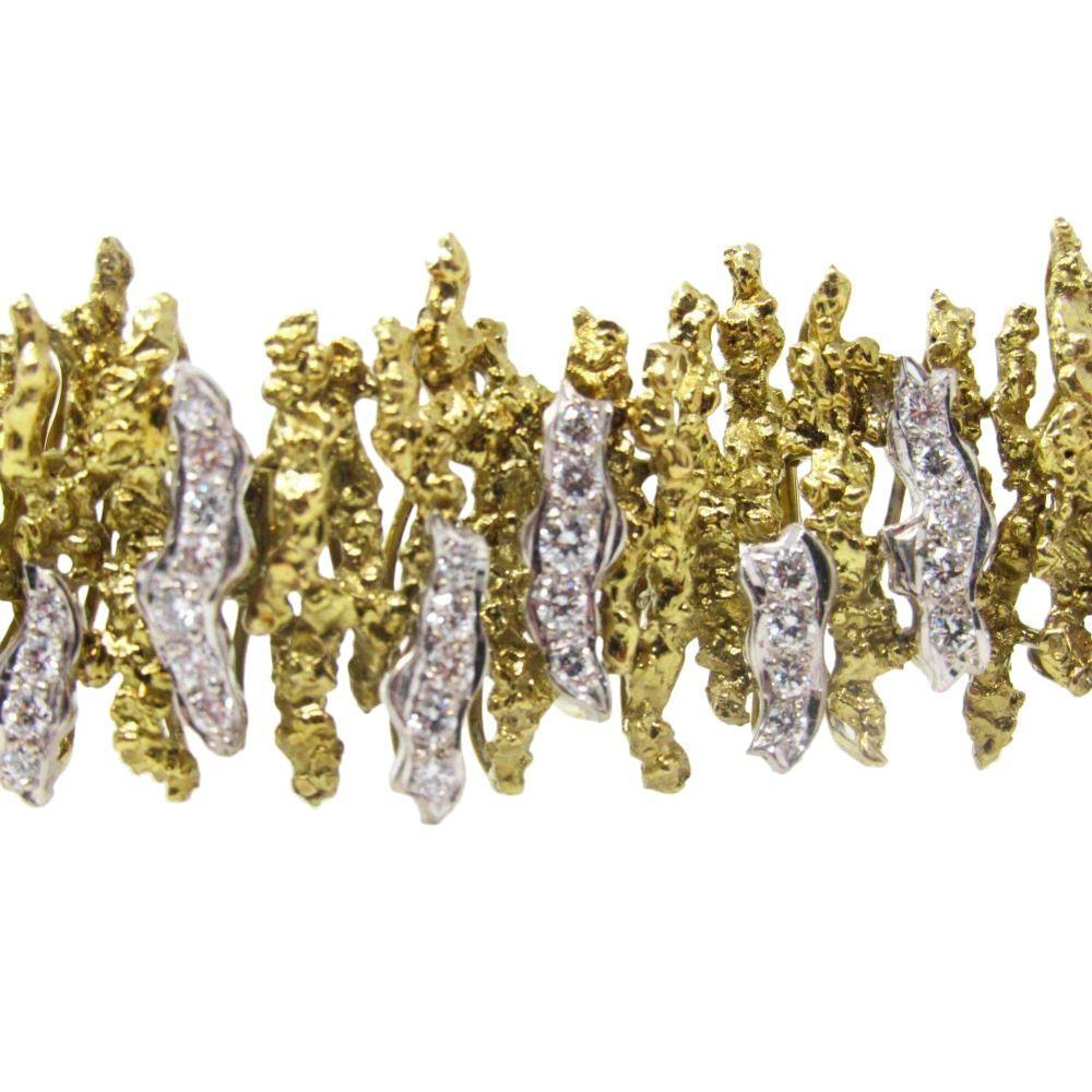 Chunky modernist 18k diamond bracelet. 18k yellow and white gold bracelet with appx. 4.0 carats or round brilliant cut diamonds. Modernist design ca. 1970 The diamonds are eye clean and white. The bracelet has tested positive for solid 18k gold.

7