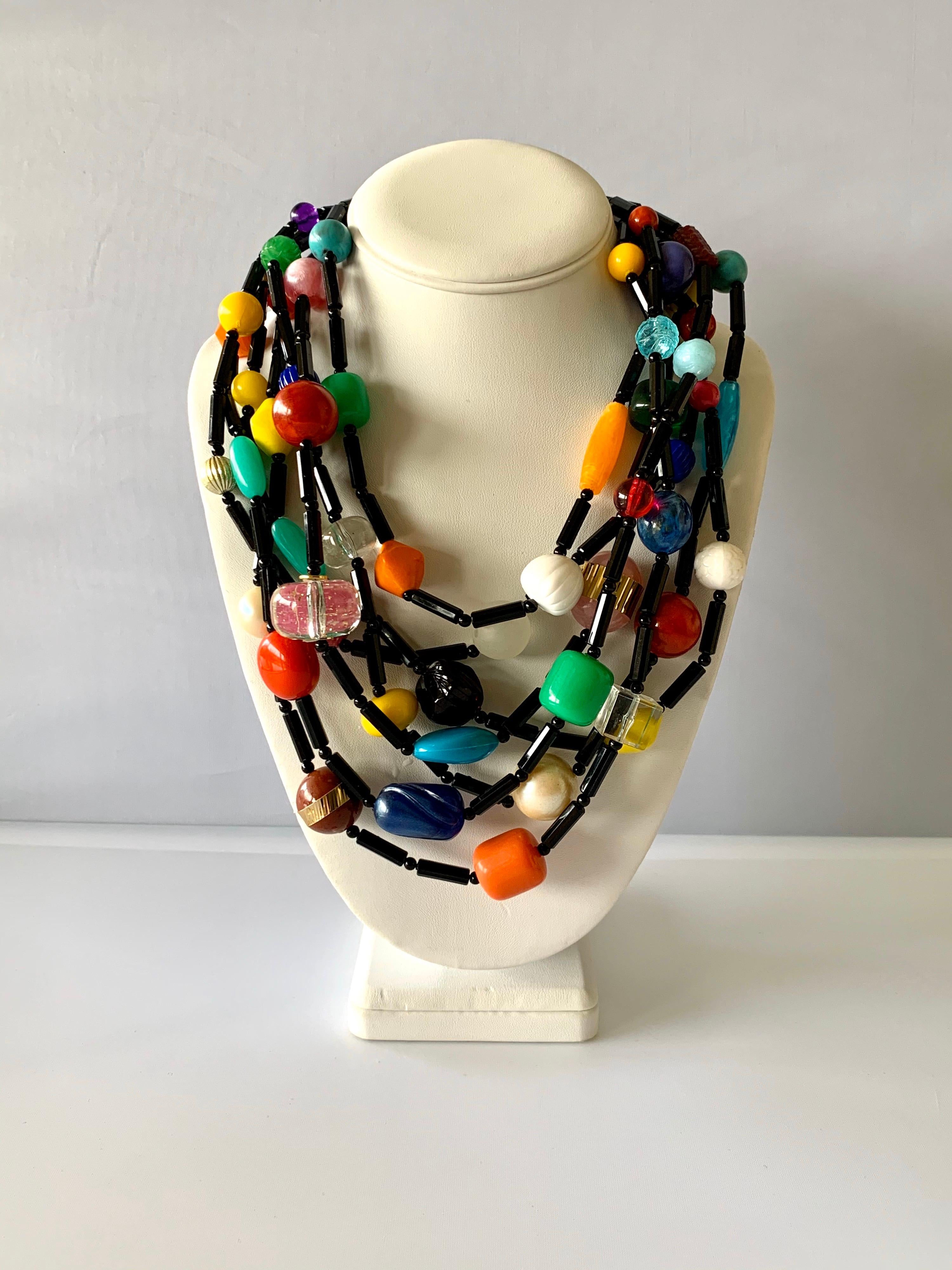 Chunky artisan multi-strand colorful statement necklace - the necklace features seven strands beaded in  round and faceted black architectural beads which are accented by an explosion of colorful phenolic beads (acrylic, bakelite and galalith) in an