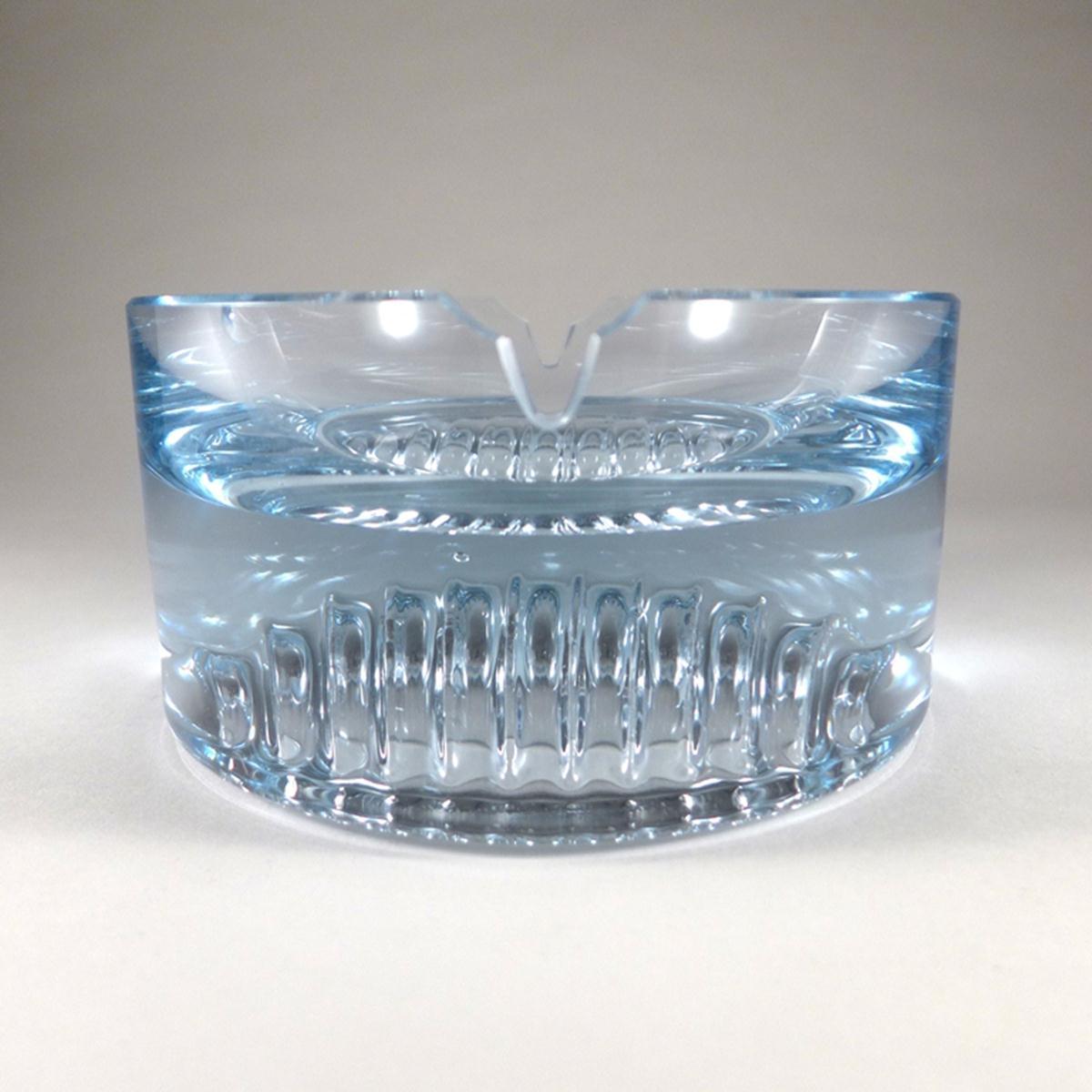 Chunky pale blue ashtray with concave wave detail on the underside.
 