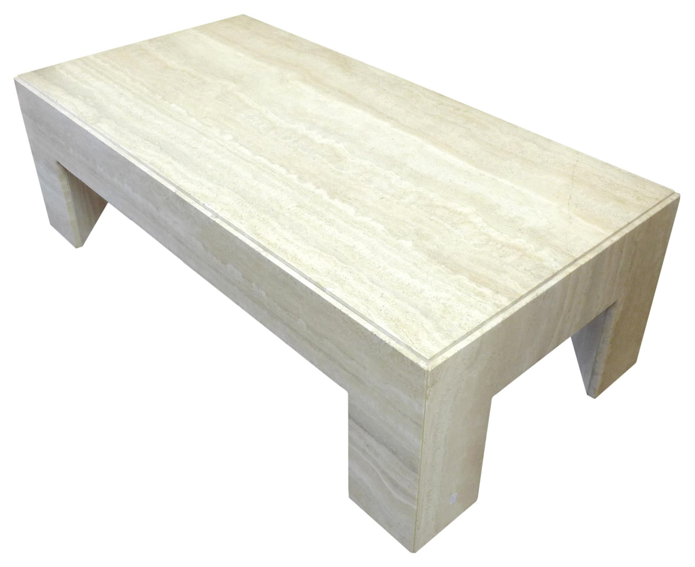 A fantastic, massive travertine coffee table. A simple yet powerful form beautifully assembled of polished travertine slabs. Nice subtle details with a slightly stepped table top and triangular legs. Great, impressive scale, proportion and material.