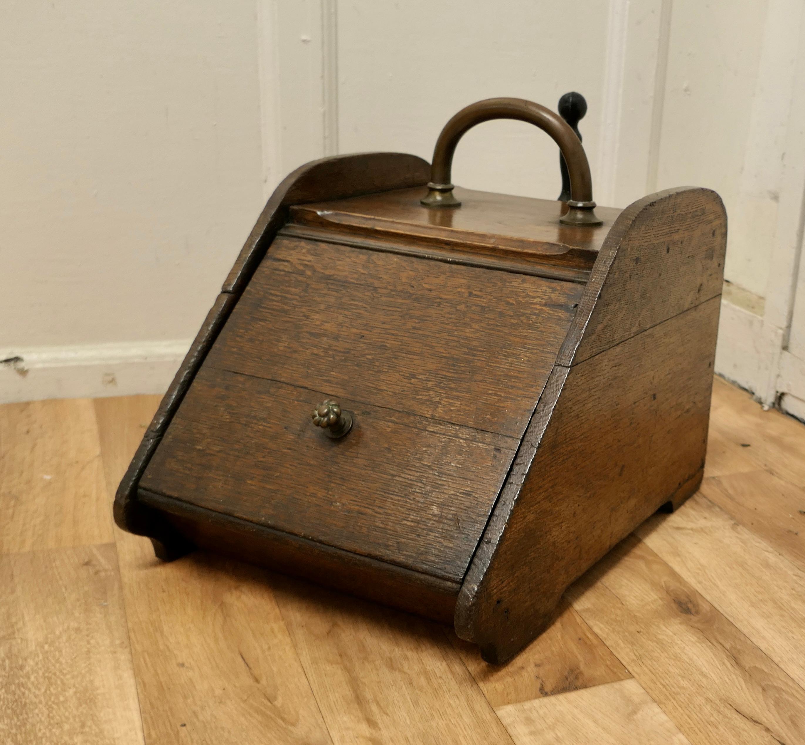 Chunky Victorian oak coal box with liner and shovel.

A charming piece of useful Victorian furniture.
The Purdonium has sloping front, hidden at the back a shovel in the shovel holder and inside a metal liner.
The box is made in solid oak and it