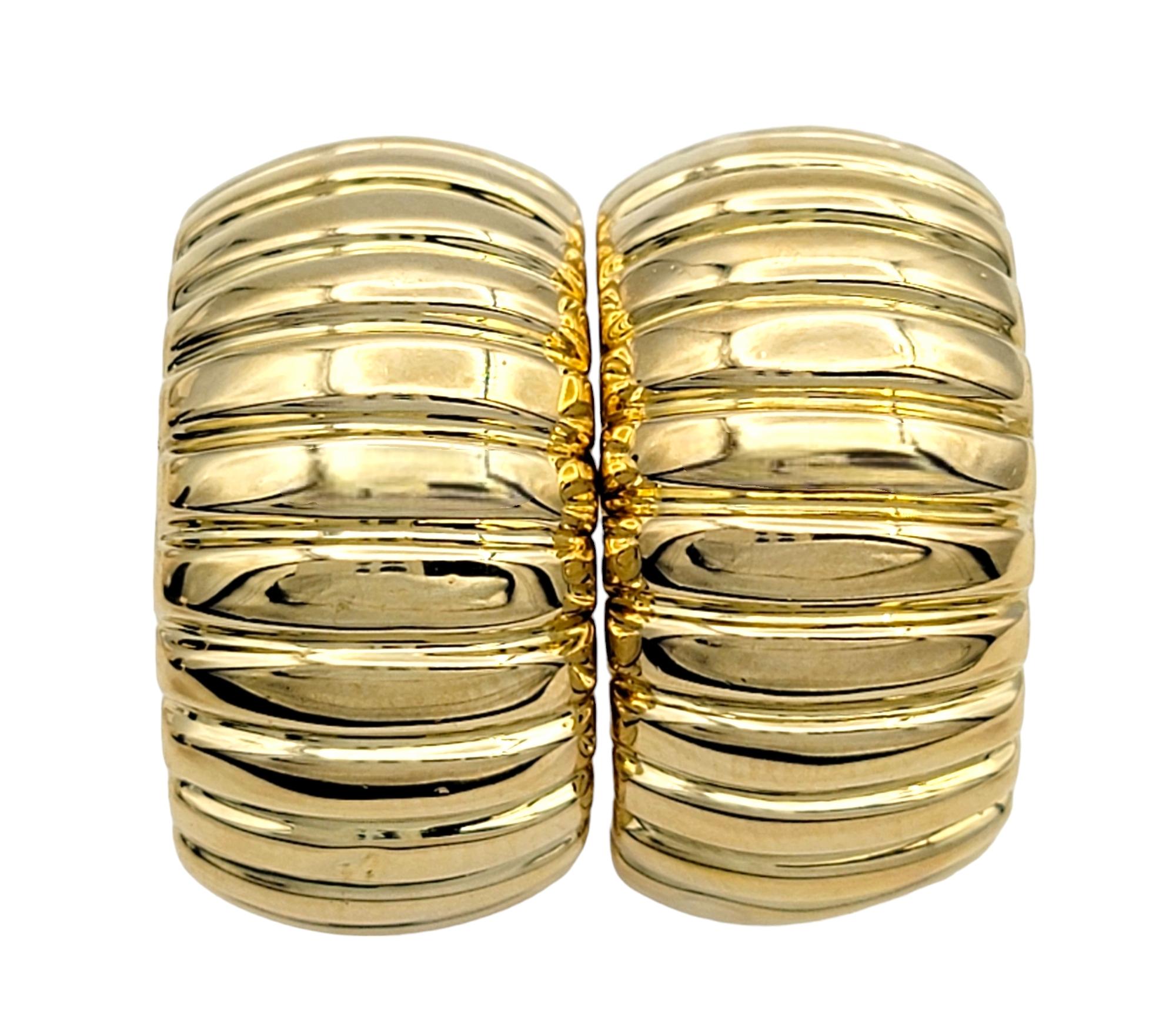 Contemporary Chunky Wide Ribbed Omega Back Hoop Earrings Set in Polished 18 Karat Yellow Gold For Sale