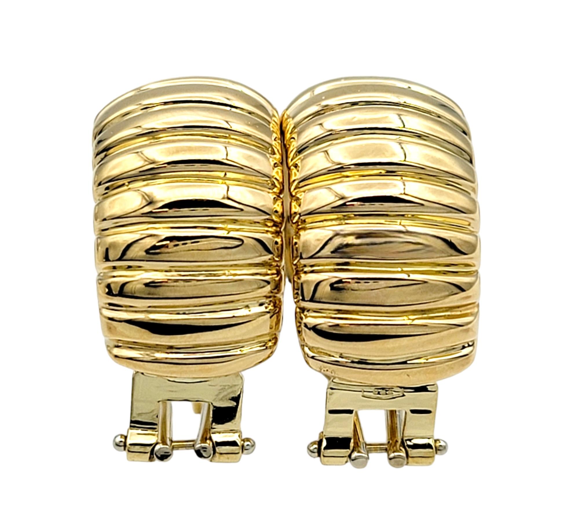 Chunky Wide Ribbed Omega Back Hoop Earrings Set in Polished 18 Karat Yellow Gold For Sale 1