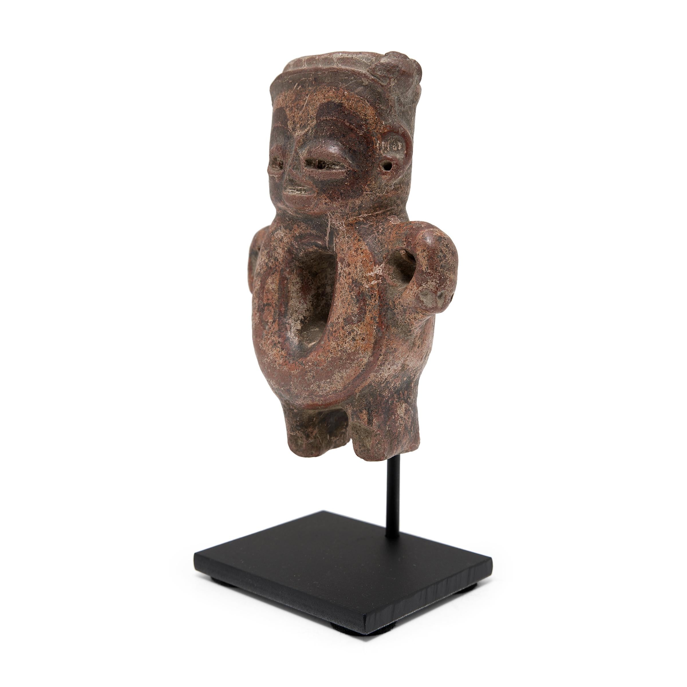 This standing effigy figure was crafted in 300 BC from the ancient Chupicuaro region of Mexico and was likely used as a ritual or burial offering. The ceramic works of the Chupicuaro people are often distinguished by their slanted, coffee-bean