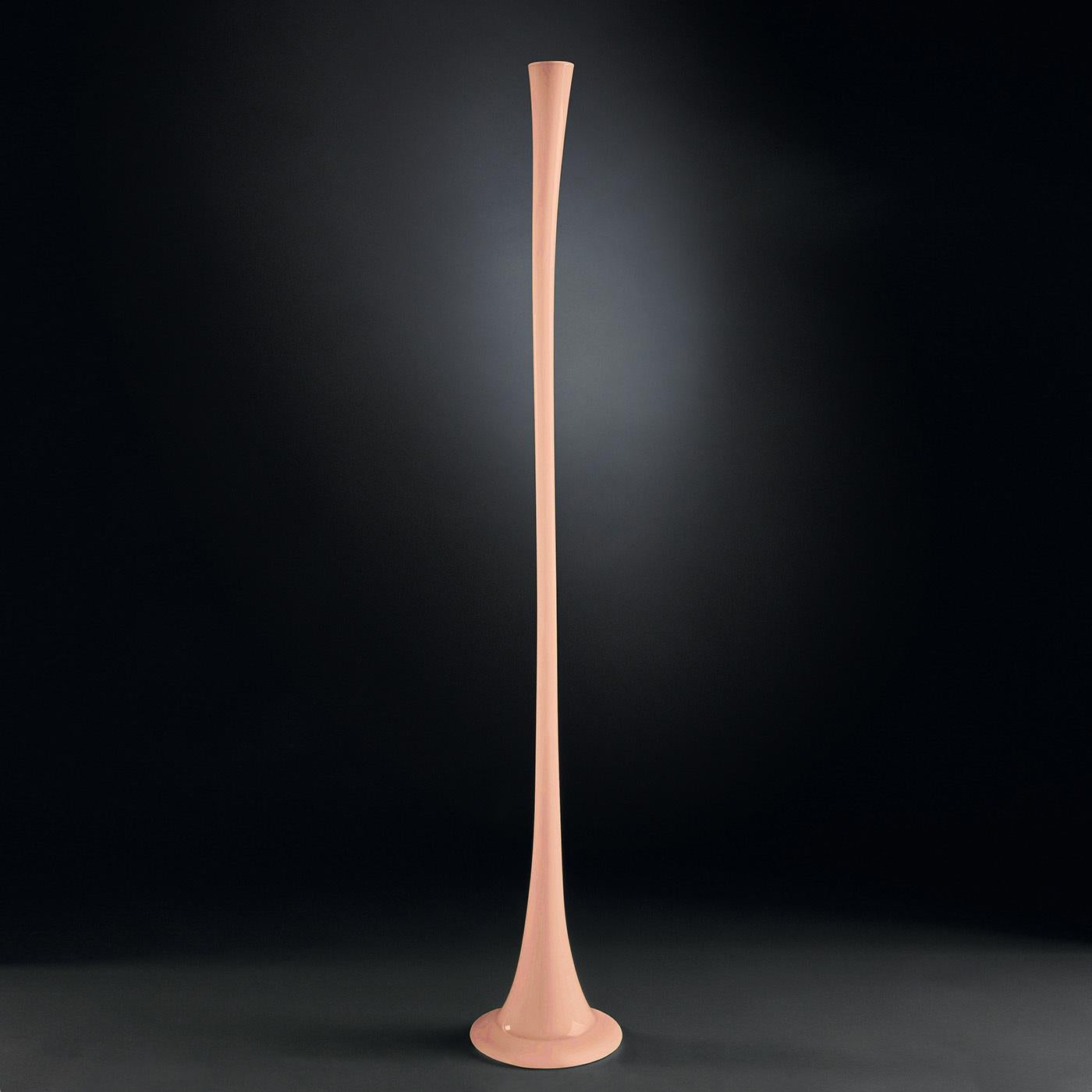 Reminiscent of the slender stem of a spring flower, this exquisite decorative vase showcases an innovative contemporary flair enhanced with a pale cantaloupe-orange hue. Masterfully handcrafted of glass, it will make a stylish addition to a