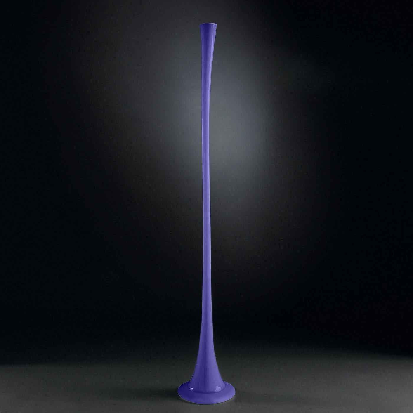 Characterized by a vivid lilac hue and a two-meter tall tapered silhouette, this decorative vase will lend a captivating and innovative quality to a contemporary interior. A refined objet d'art, it is superbly handcrafted of glass by master artisans