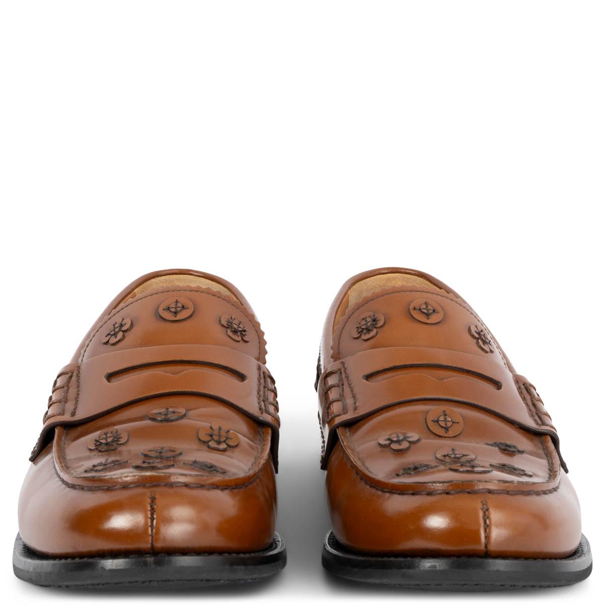 100% authentic Church's classic penny loafers in cognac glossy leather embellished with tonal leather flowers. Have been worn and are in excellent condition. 

Measurements
Imprinted Size	40
Shoe Size	40
Inside Sole	27cm (10.5in)
Width	8cm