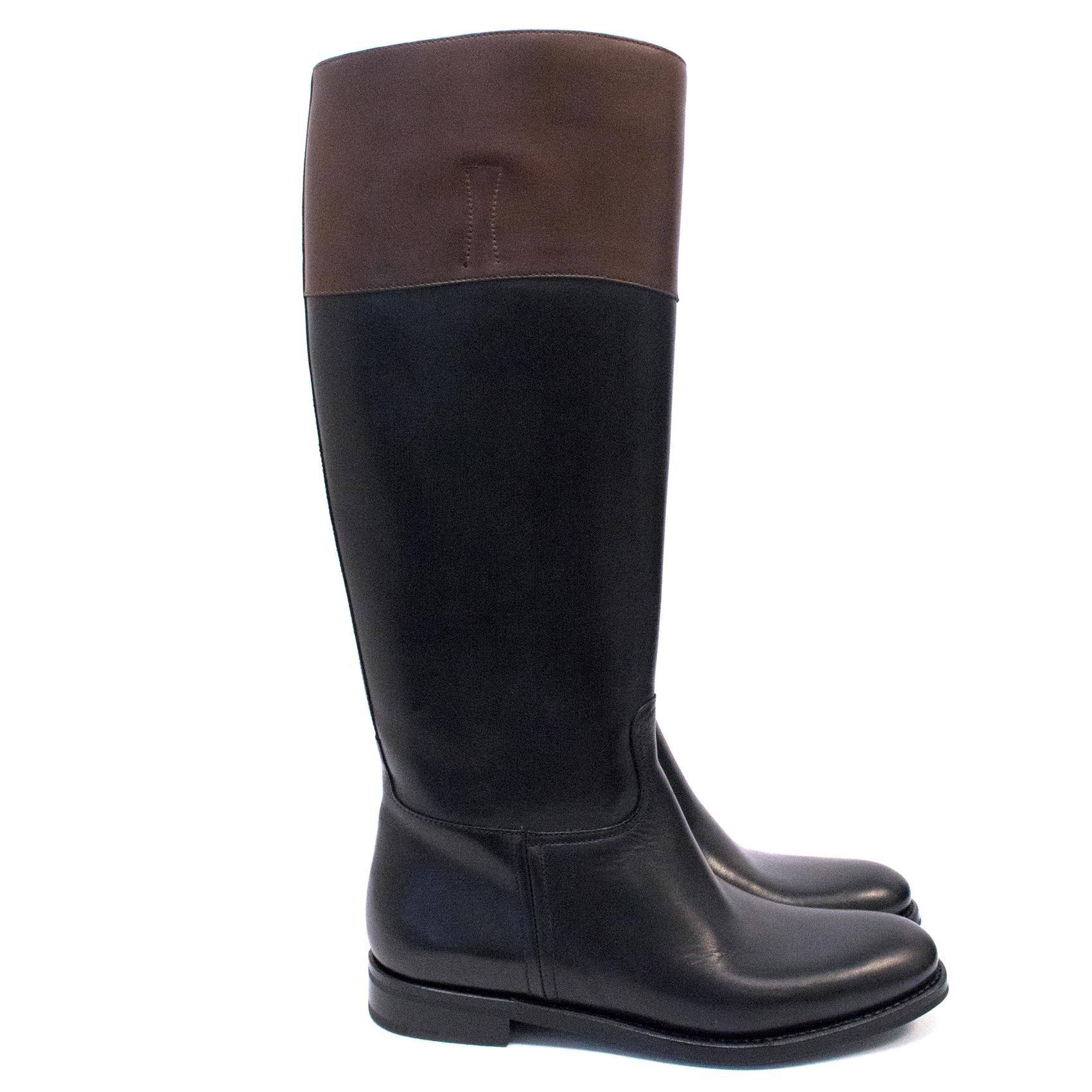 Church's black riding knee-high boots with brown upper trim.
Flat style in a pull-on style.
Almond-shaped toe.
Current collection.
Item is brand new.

Approx.

Length - 28cm

Height - 42cm

Width - 9cm