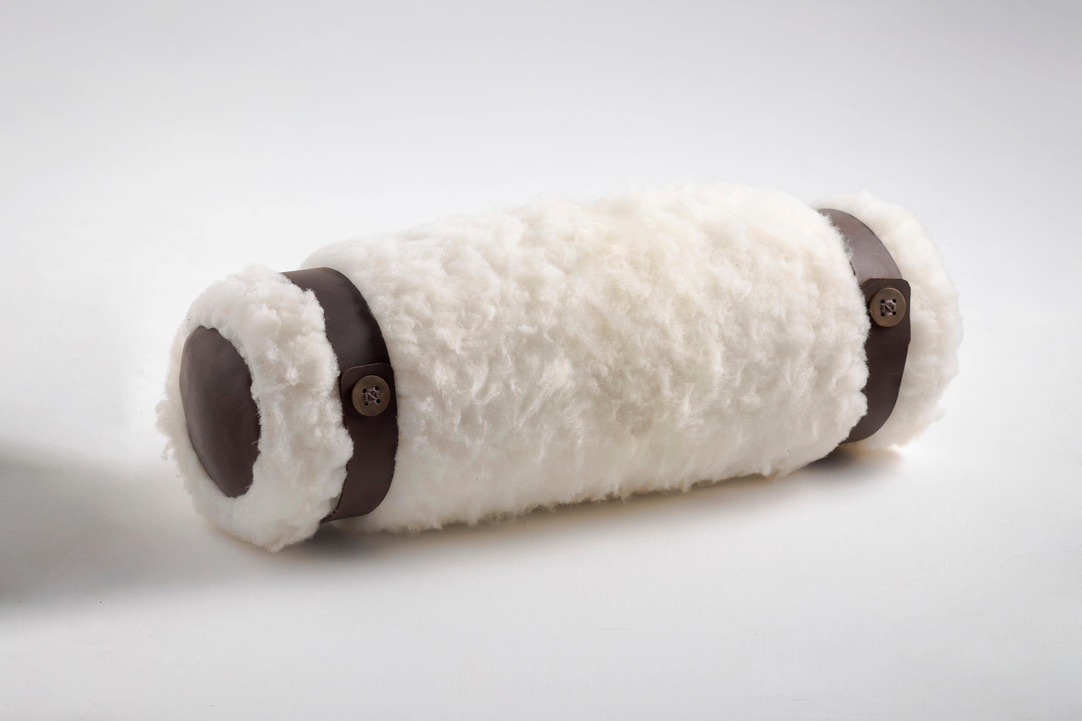 Decorative bolster pillow with artisanal sheepskin from Cotacachi, Imbabura.

These decorative cushions are carefully hand-crafted with cotton embroidery and enriched with accents of sheep fur and hand stitched leather. They feature traditional