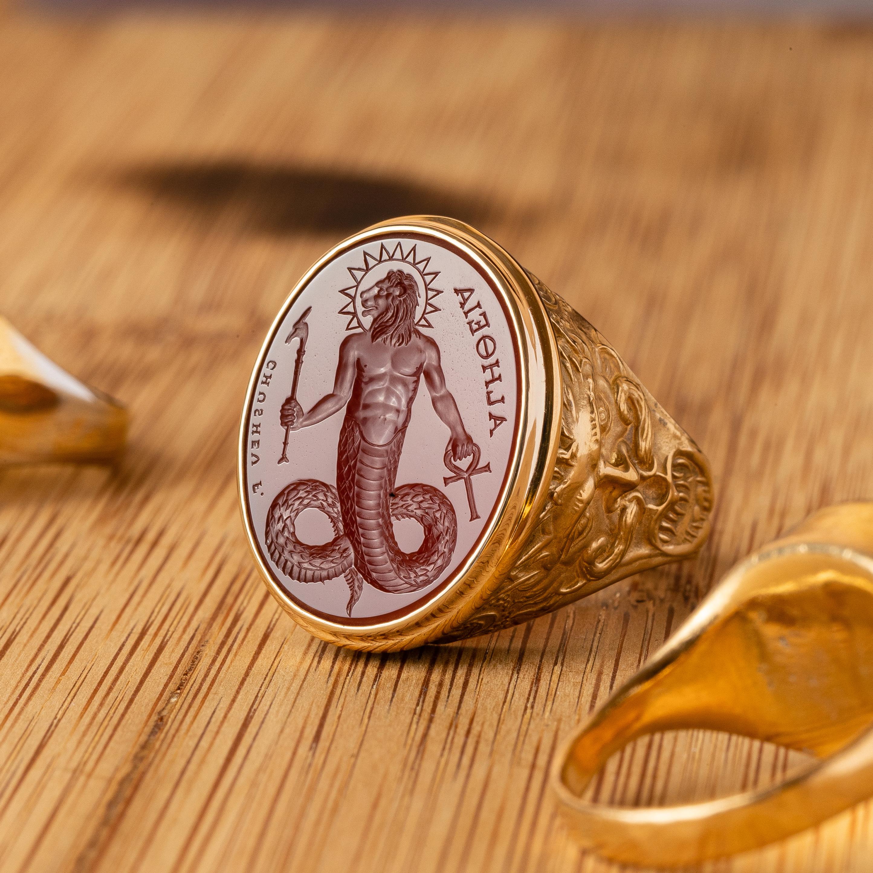 This exquisite intaglio is masterfully engraved onto rich carnelian gemstone and features the Gnostic deity, Chnoubis. The stone is set in an 18K signet ring.

Production time for this piece is up to 10 weeks.

Can be made in any size ranging from
