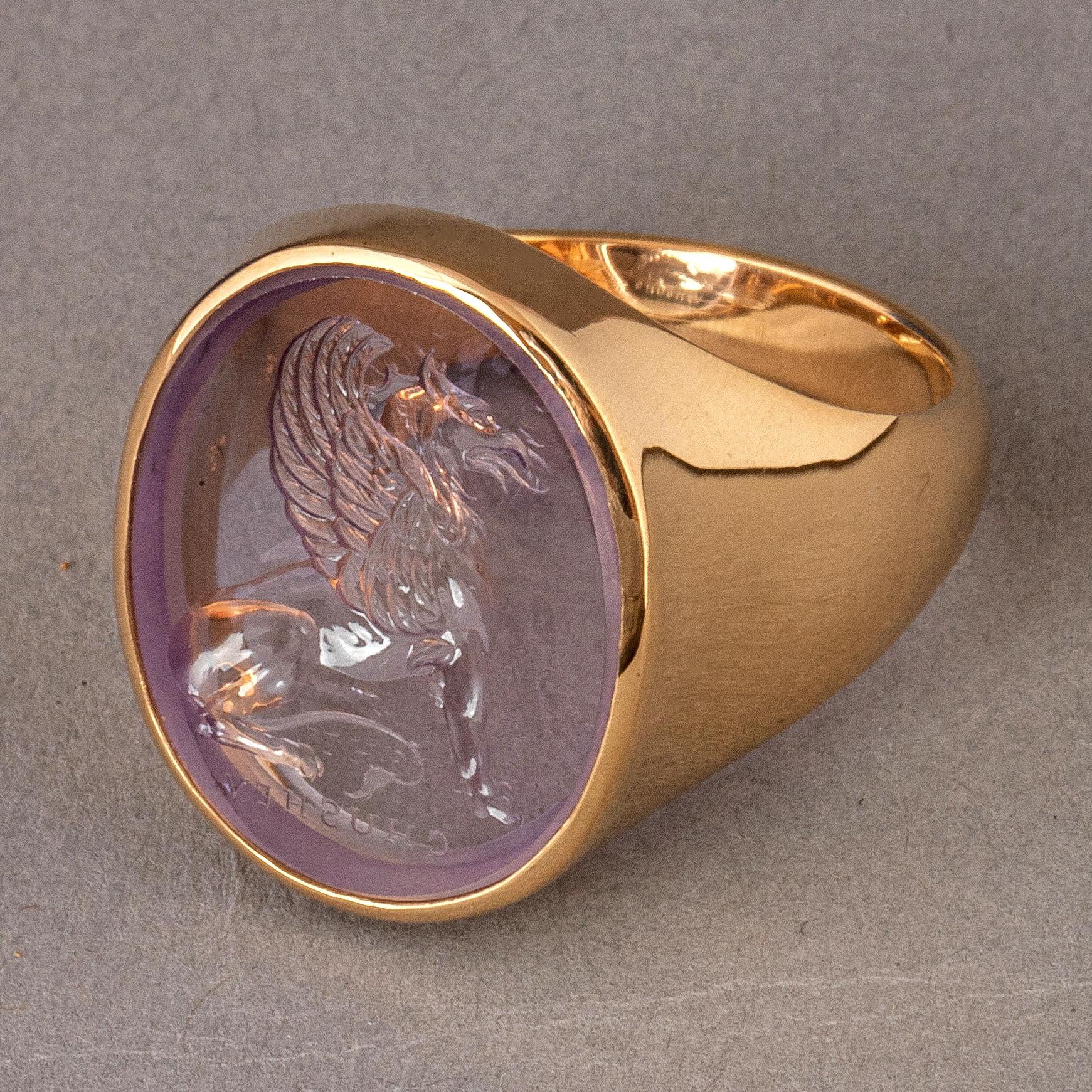 This exquisite intaglio is engraved onto amethyst crystal and features a griffin, which throughout history, has been regarded as a protective creature. The amethyst stone is set in an 18K signet ring.

Production time for this piece is 4-6
