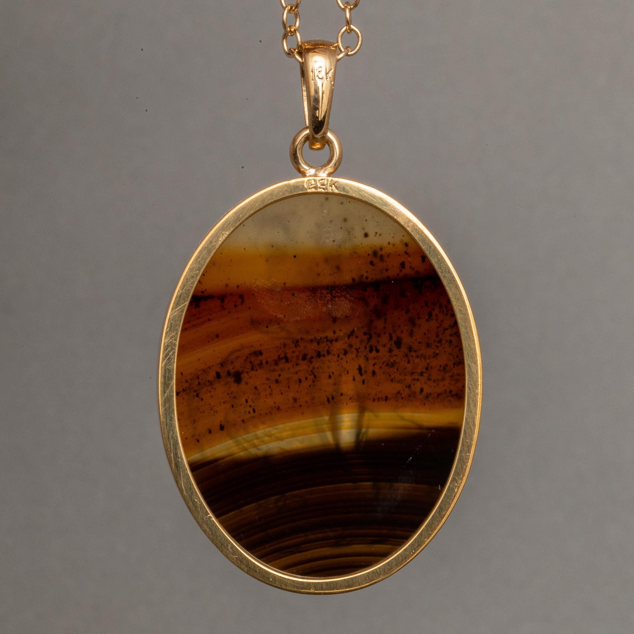 This exquisite intaglio is masterfully engraved onto a Montana agate specimen and features a depiction of Hebe & Zeus. The stone is set in a 18K karat gold pendant. Montana agate is highly prized for its rich color and striking patterns.

Hebe was