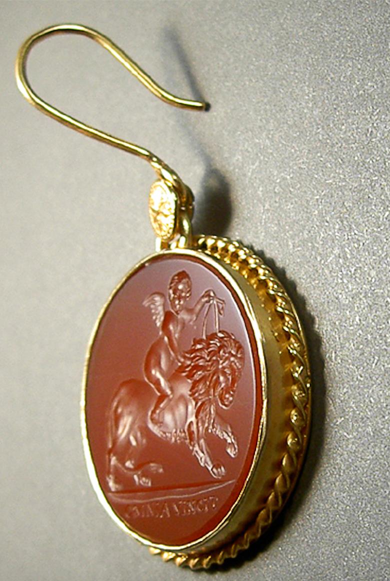 These exquisite intaglios are masterfully engraved onto carnelian gemstone and feature cupid riding a lion. The stones are set in a 18K karat gold earrings.

Production time for this piece is 4-6 weeks.

Chavdar Chushev is an artist, restorer,