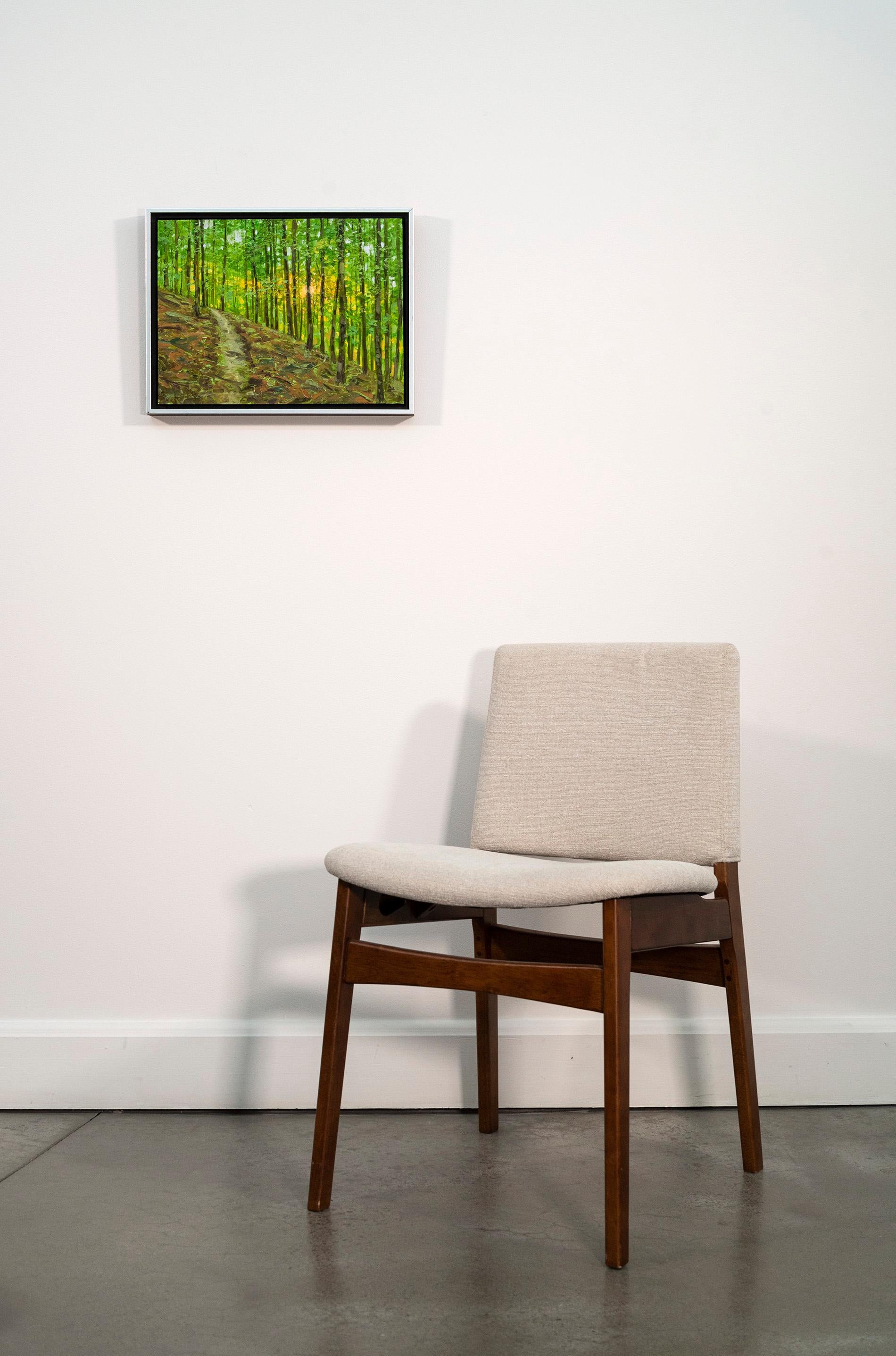 This realistic oil landscape painting is by an artist whose work is collected internationally.

The peace of a forest glade, the sun filtered through leafy green, a path on a slope beckons. This is the work of Ciba Karisik. His realistic oil