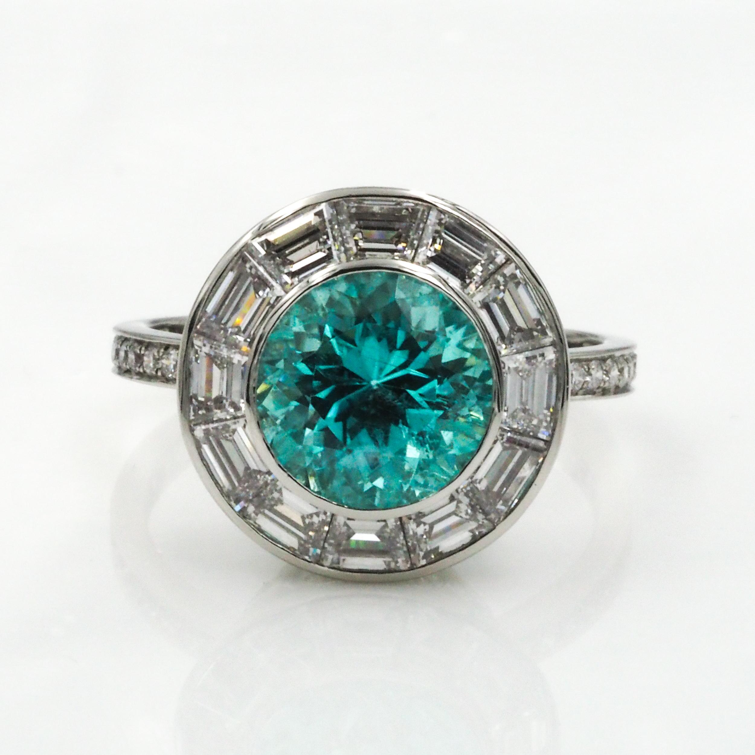 An original creation by Cicada Jewelry. This platinum cocktail ring features a beautiful round paraiba tourmaline, surrounded by baguette diamonds. The basket is finished with marquise diamonds, and the shank with melee diamonds.

Paraiba: