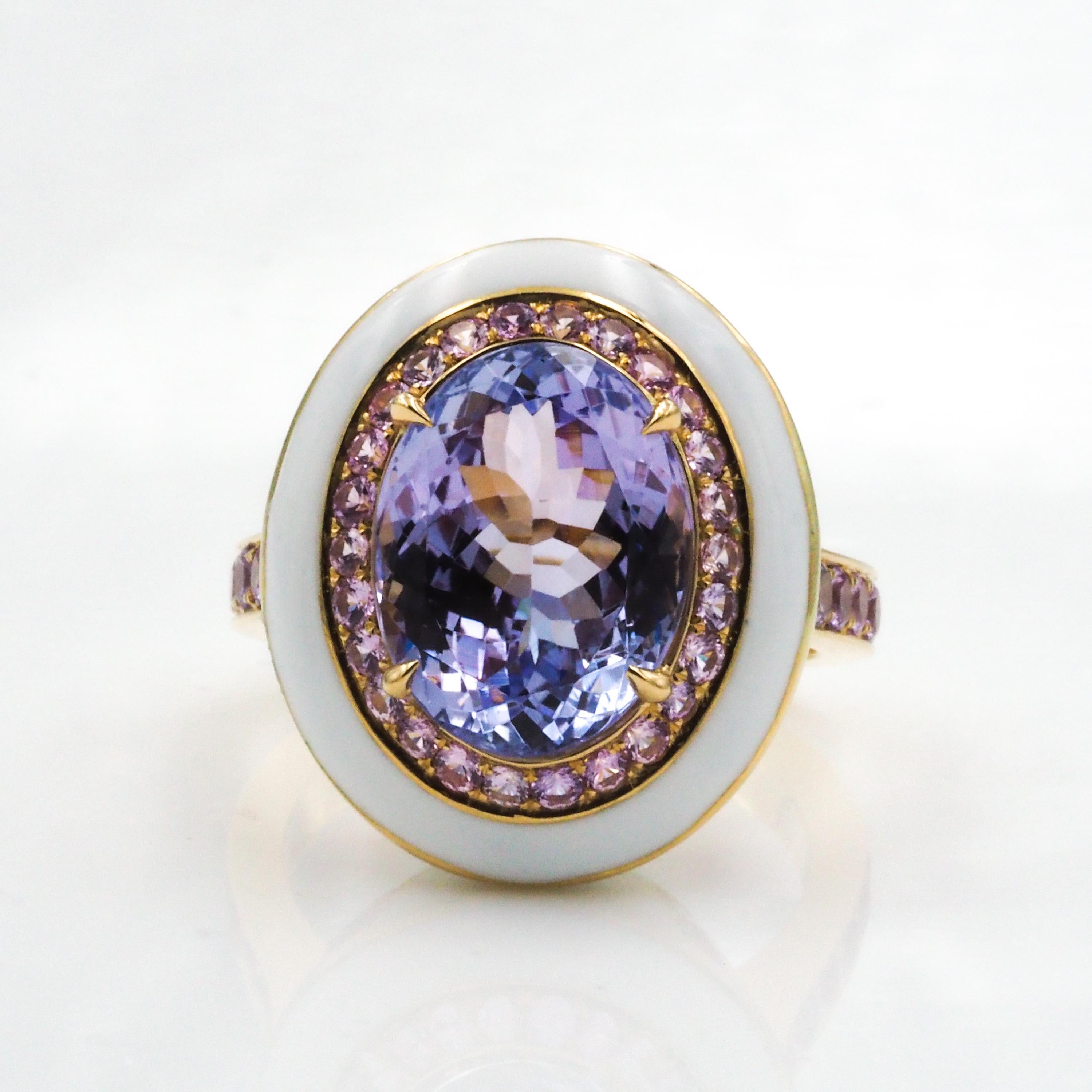 This 18k yellow gold cocktail ring features an oval tanzanite center, surrounded by pink sapphires. The white enamel ceramic enhances the color of the beautiful center stone.

Tanzanite Center: 9.66ct
Pink Sapphires: 1.74ct
Metal: 18k Yellow