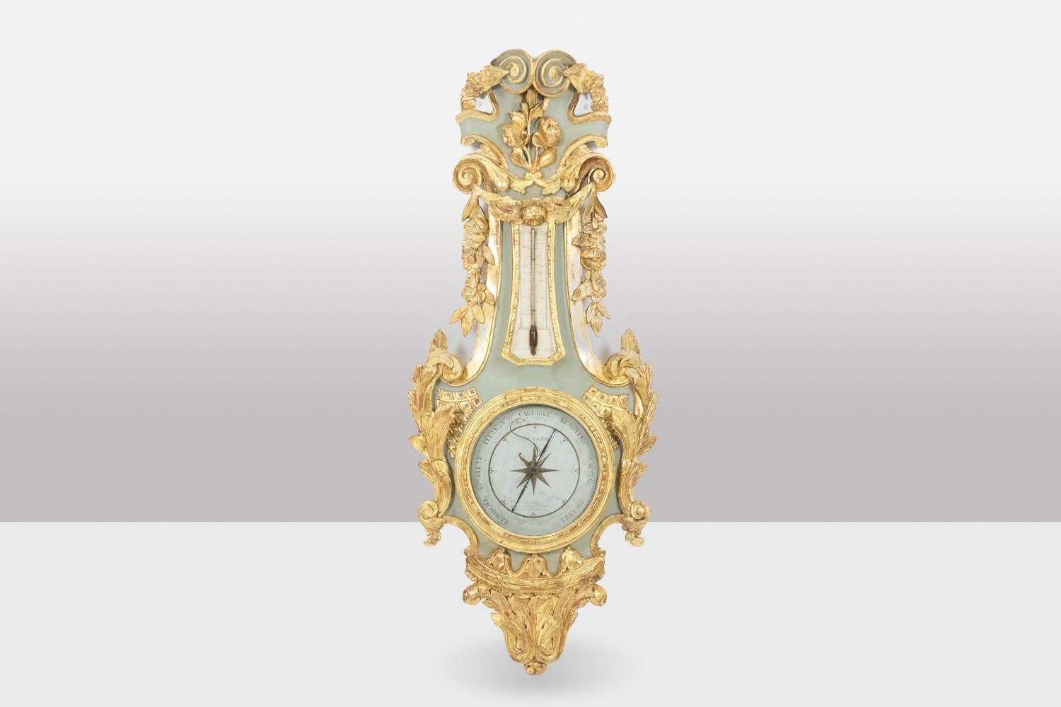 Cicery, signed.

Barometer-thermometer in carved and gilded wood with its lacquered background in green tones, the circular-shaped barometer in the central part, the rectangular-shaped thermometer in the upper part. In the upper part, waves,