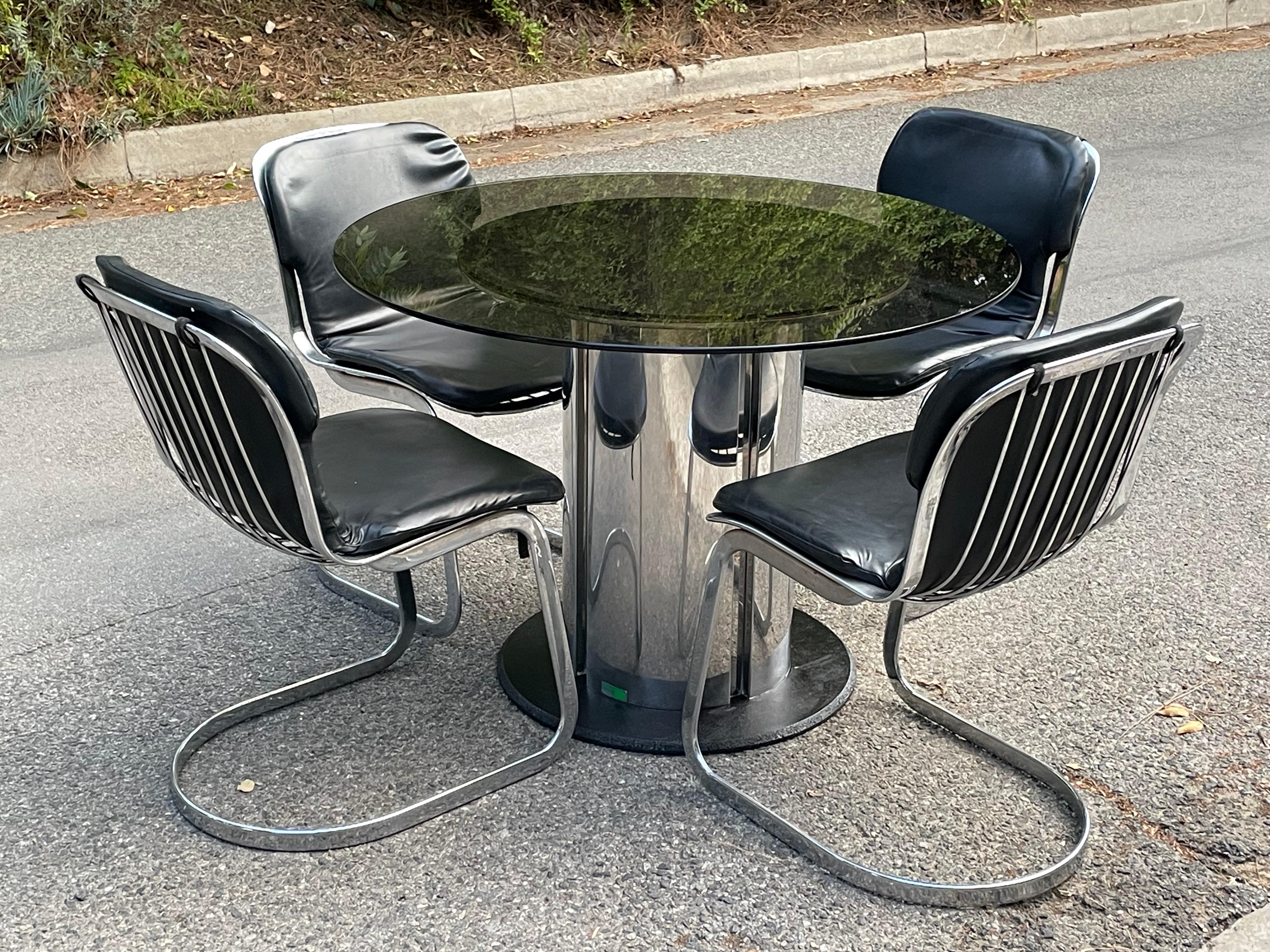 Mid Century 60's stainless steel chromed table with smoked glass top designed by Antonia Astori for Cidue.

Table has features a thick cylinder shaped, chrome plated metal base on a flat round foot.

Made in Italy.
Table ia SIGNED with Cidue label.