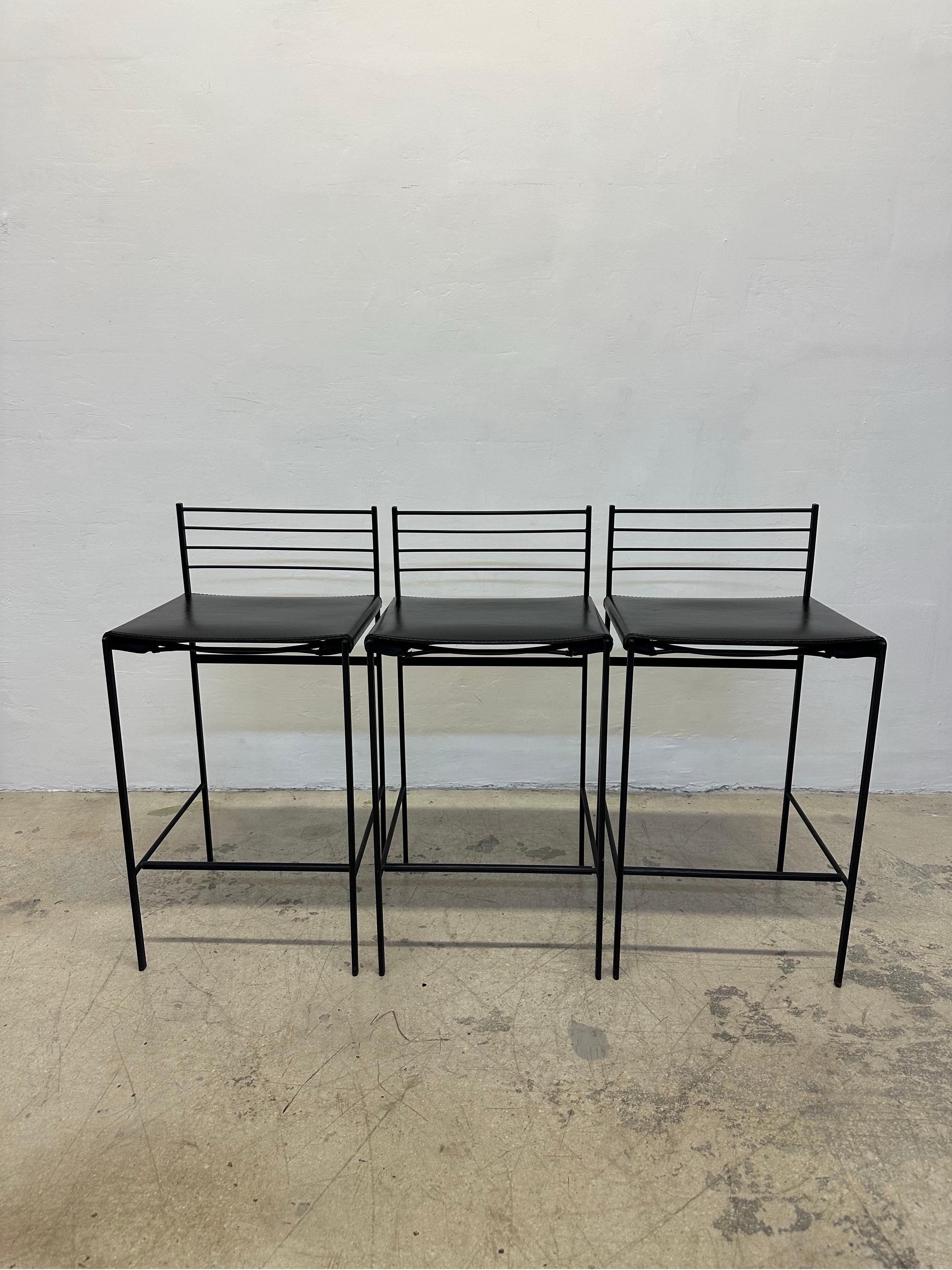 Set of three postmodern Alice counter stools with black leather seats on a black steel frame by Cidue Italy circa 1980s.