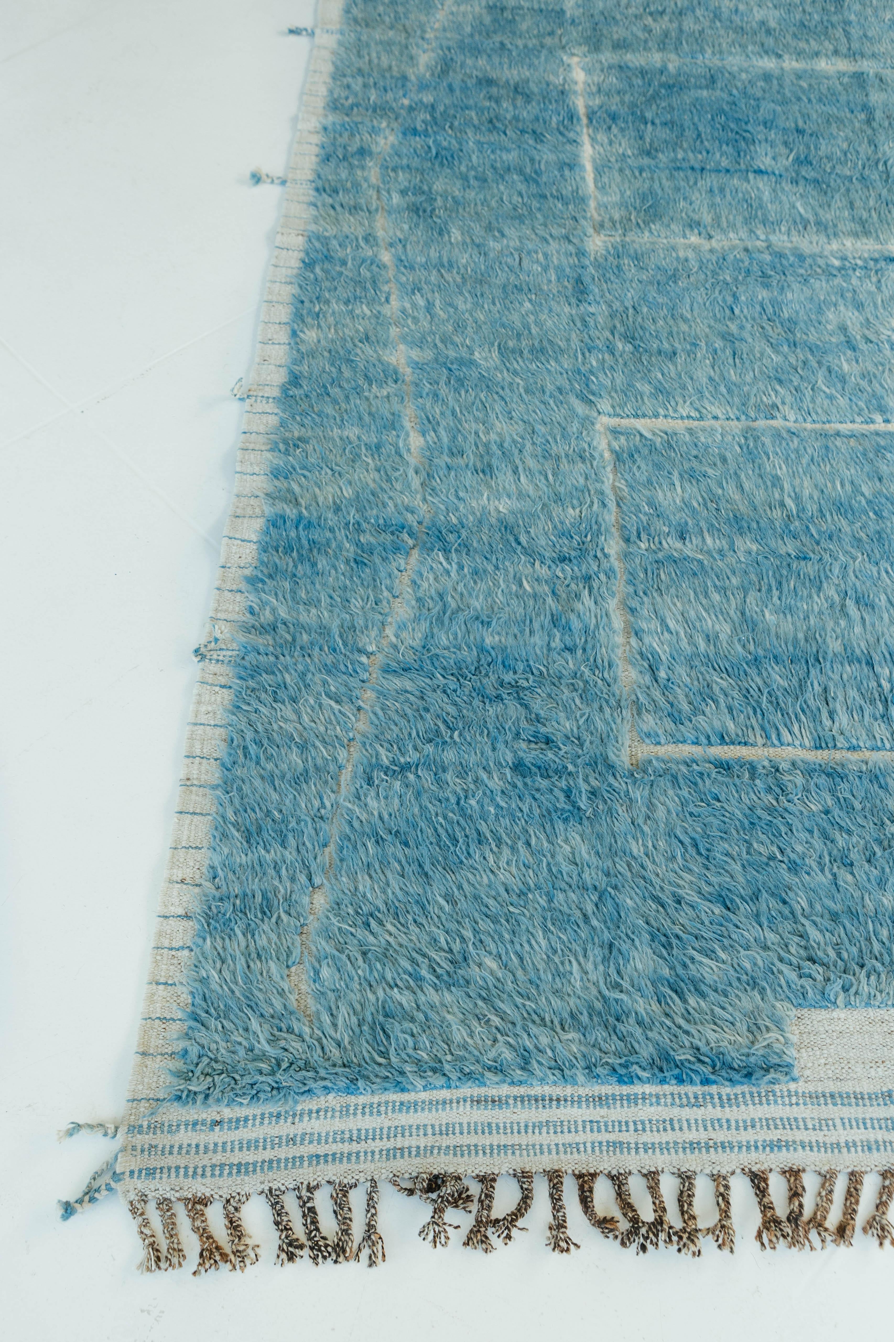 Cierzo is a handwoven wool rug made of an ocean blue shag and a natural white flat-weave seen through the embossed detailing. A part of the Haute Bohemian Collection, designed in California, named for the winds knitting together seasons, trees,